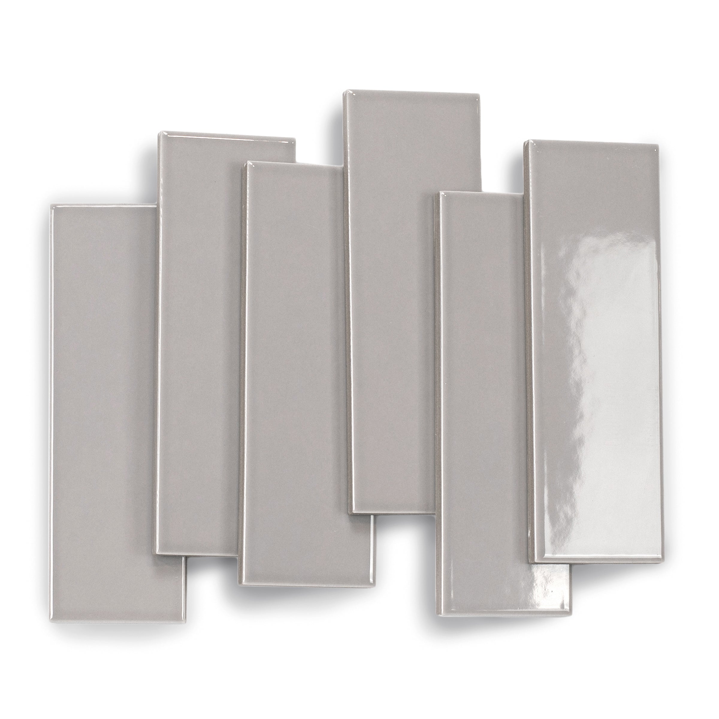 Glossy porcelain tile in muted ash tone with smooth surface and clean edges layered in an overlapping arrangement