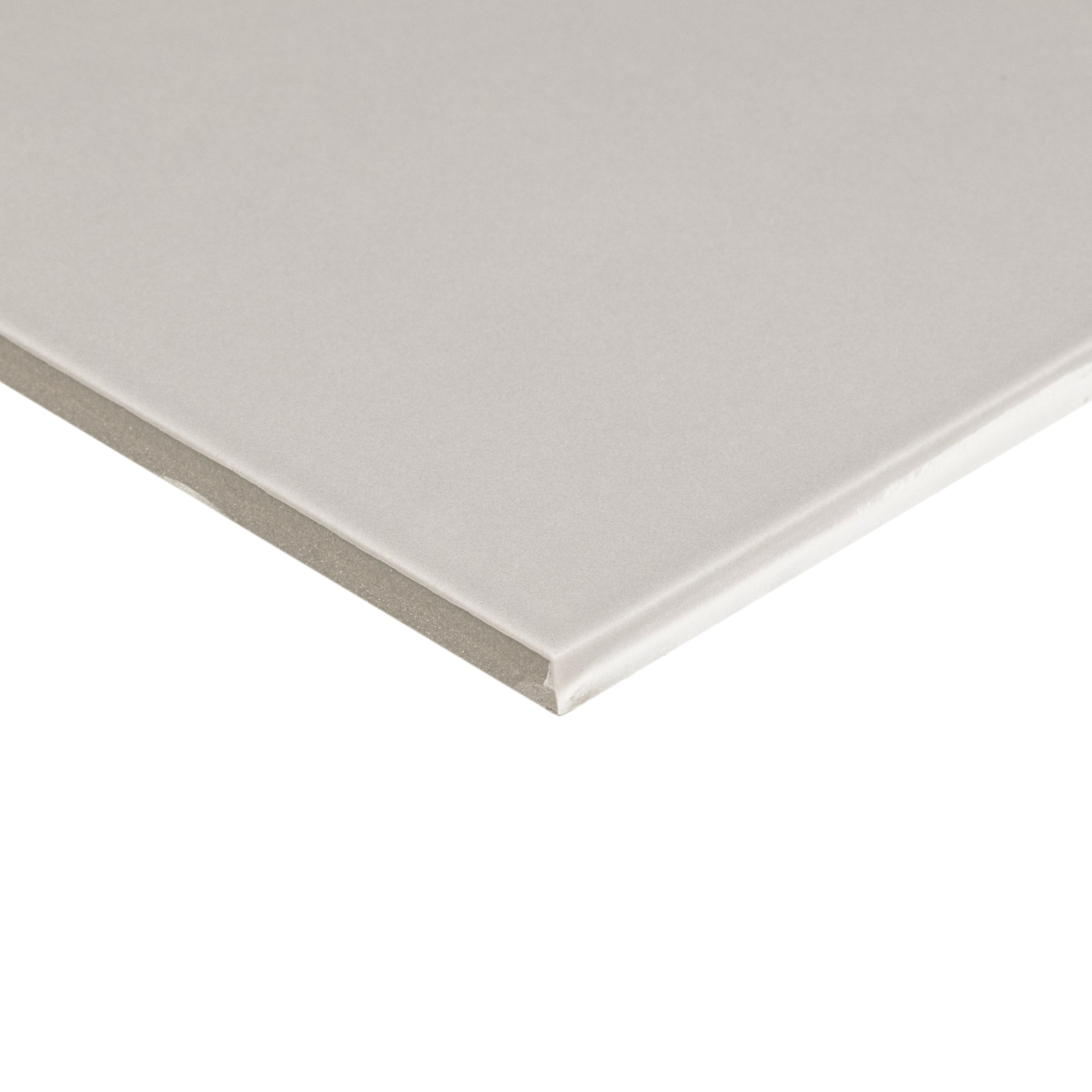 Close-up of a light gray matte porcelain tile corner highlighting smooth surface and precise straight edges for flooring or walls