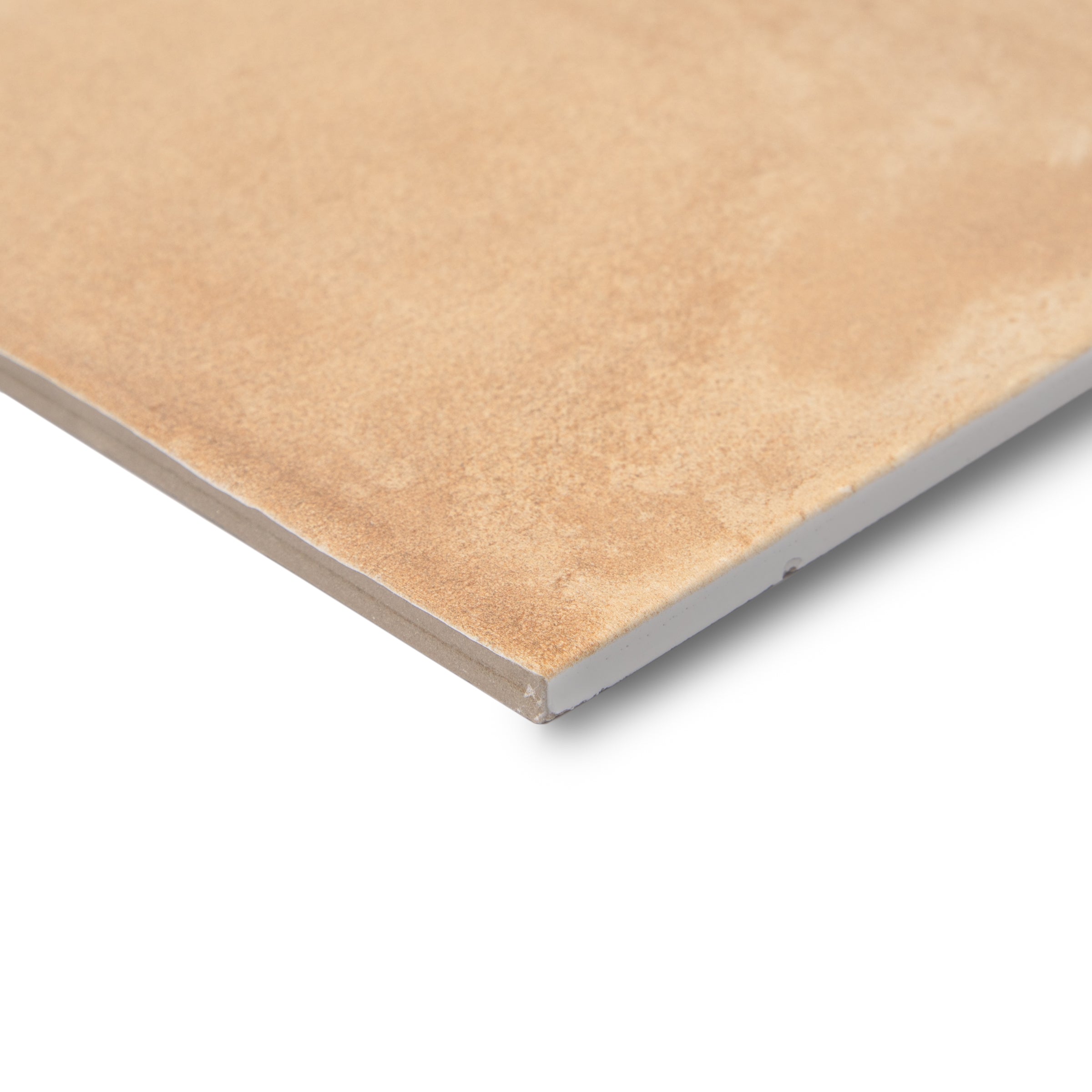 Close-up of a warm terracotta-colored porcelain tile with a smooth matte finish and subtle texture on a white background