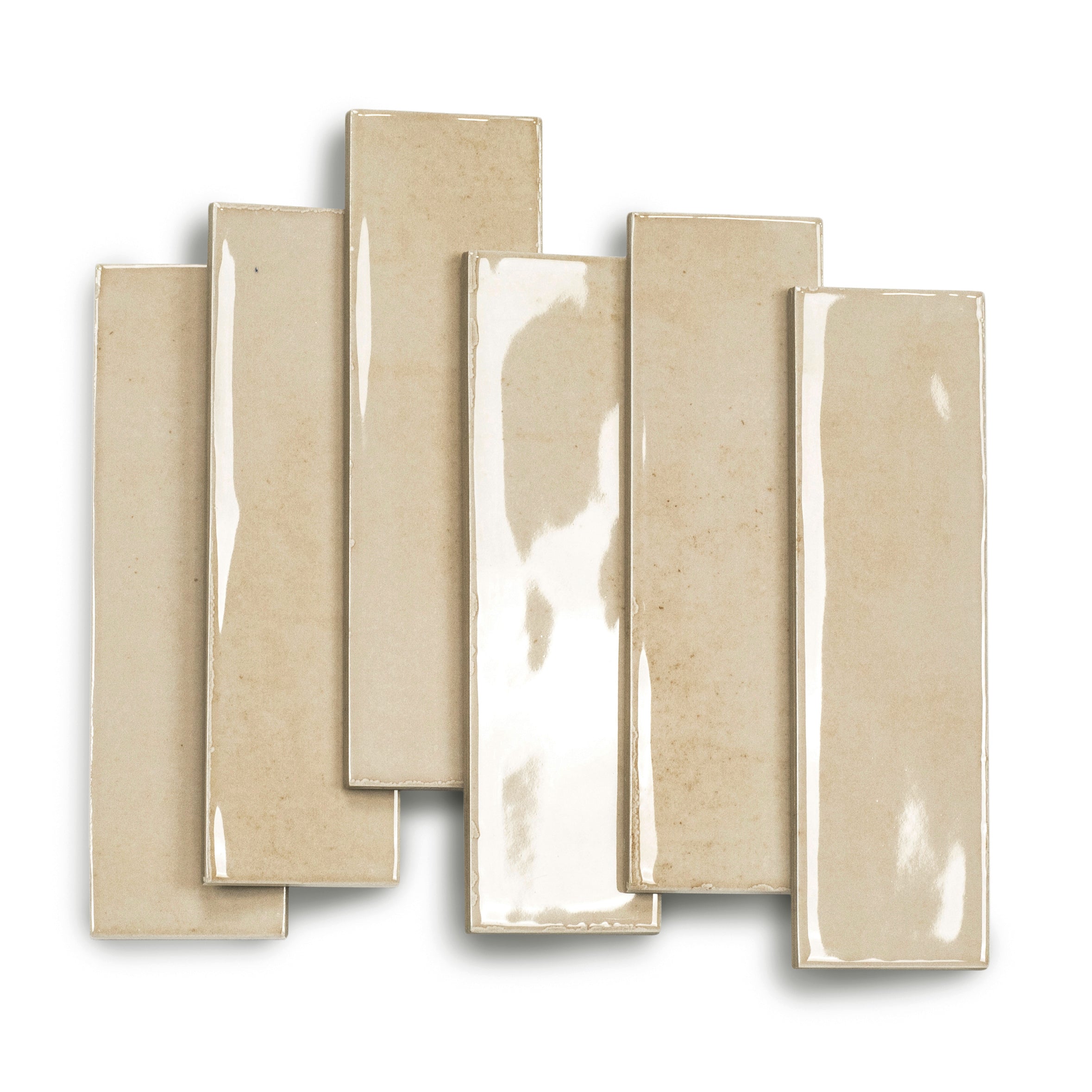 Glossy bone-colored ceramic tiles in varying lengths with a smooth surface reflecting light subtly