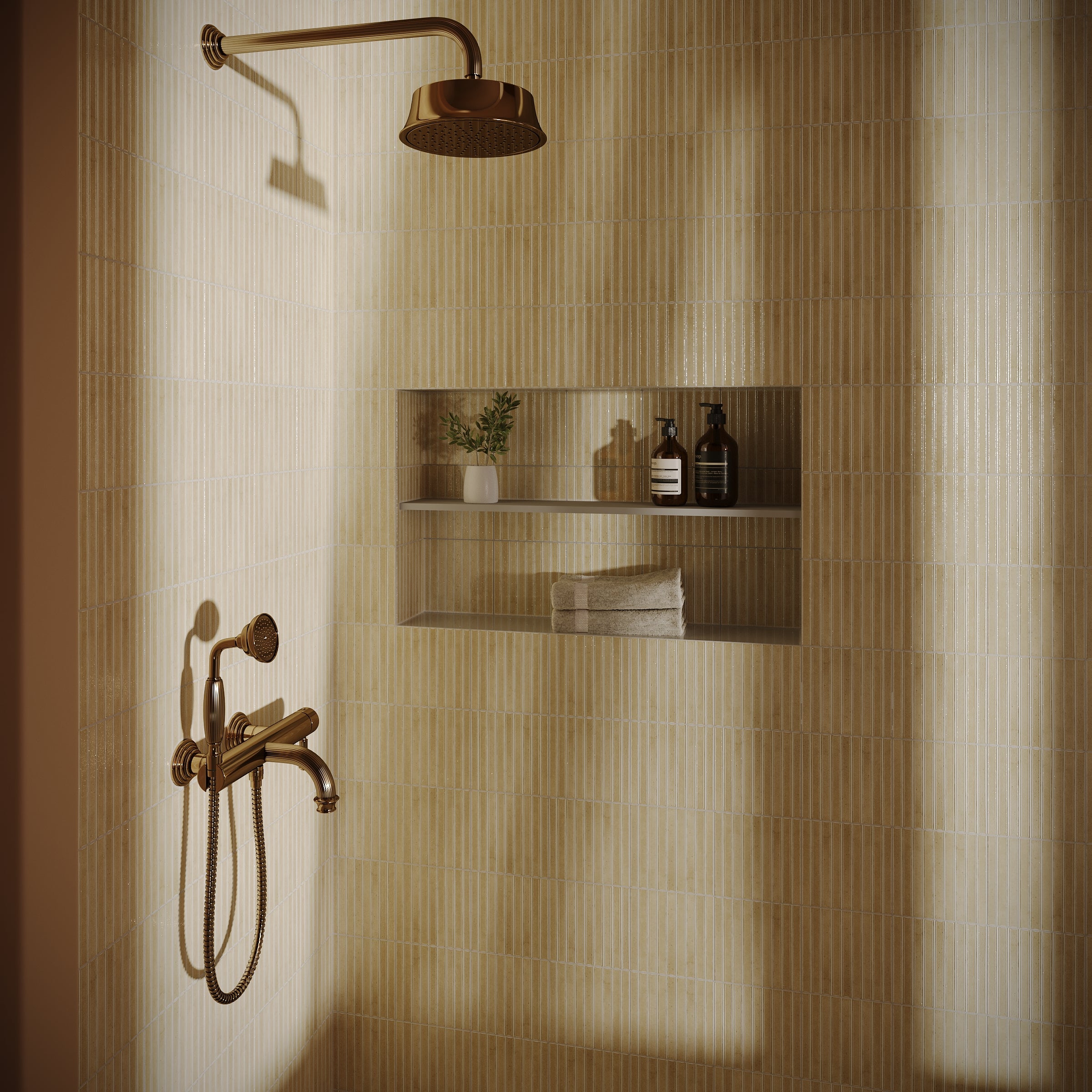 Matte beige ceramic tiles with subtle vertical texture surround a bronze shower fixture and recessed niche with toiletries and towel.