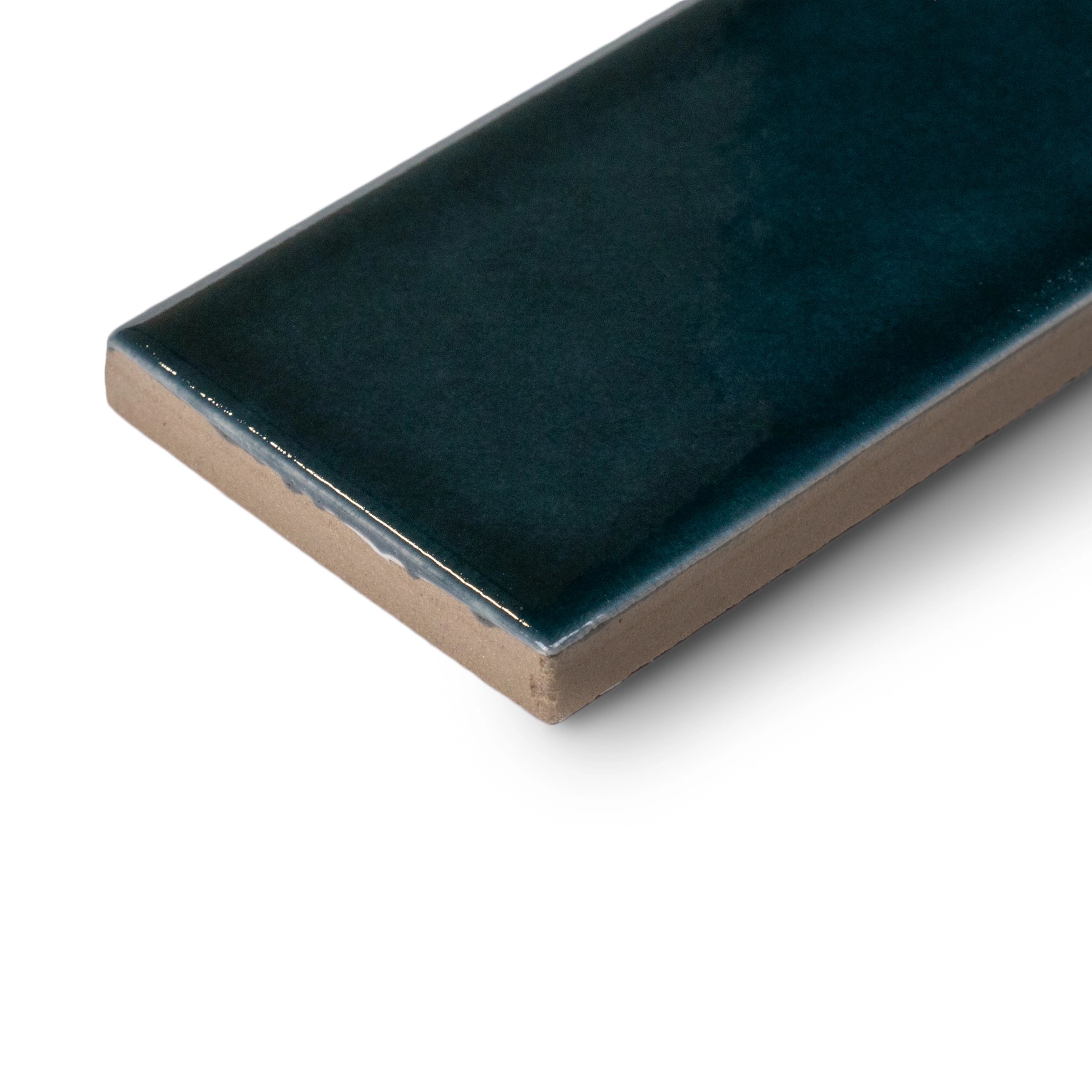 Rectangular ceramic tile in deep glossy teal with smooth edges and slightly reflective surface on white background