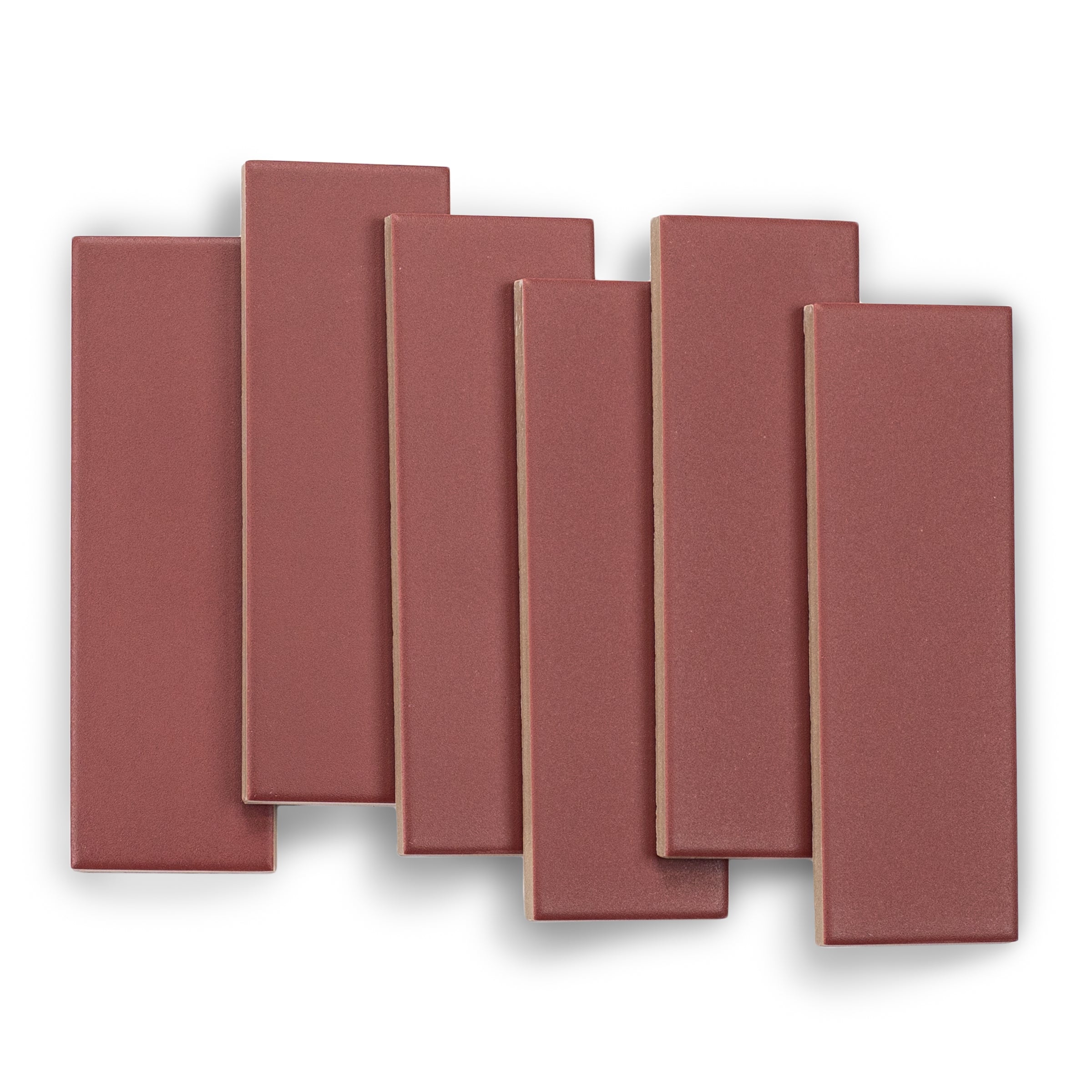 Seven matte porcelain tiles in a muted burgundy shade with smooth surfaces and clean edges arranged on a white background