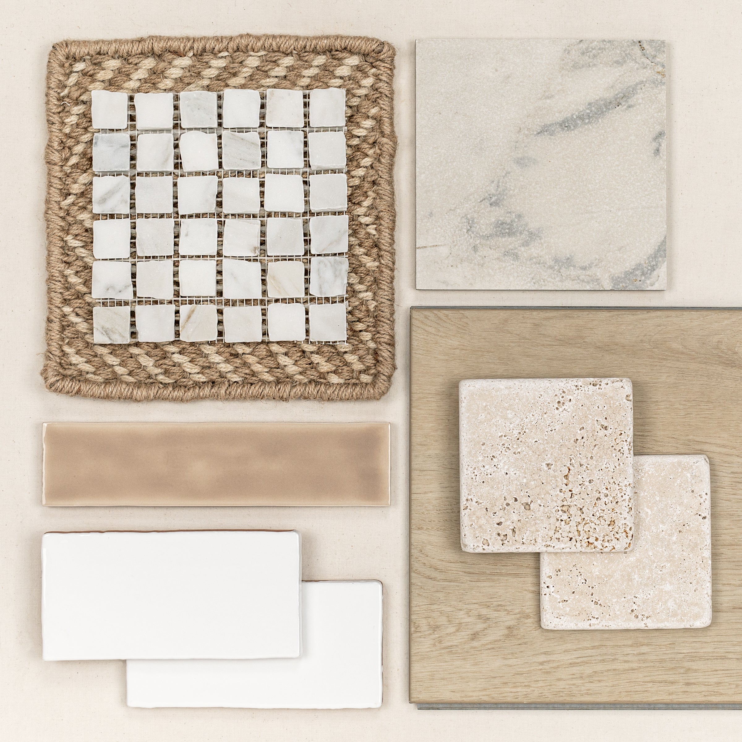 Collection of neutral-toned tile samples including marble mosaic, beige porcelain, travertine, and wood-look flooring on a light background
