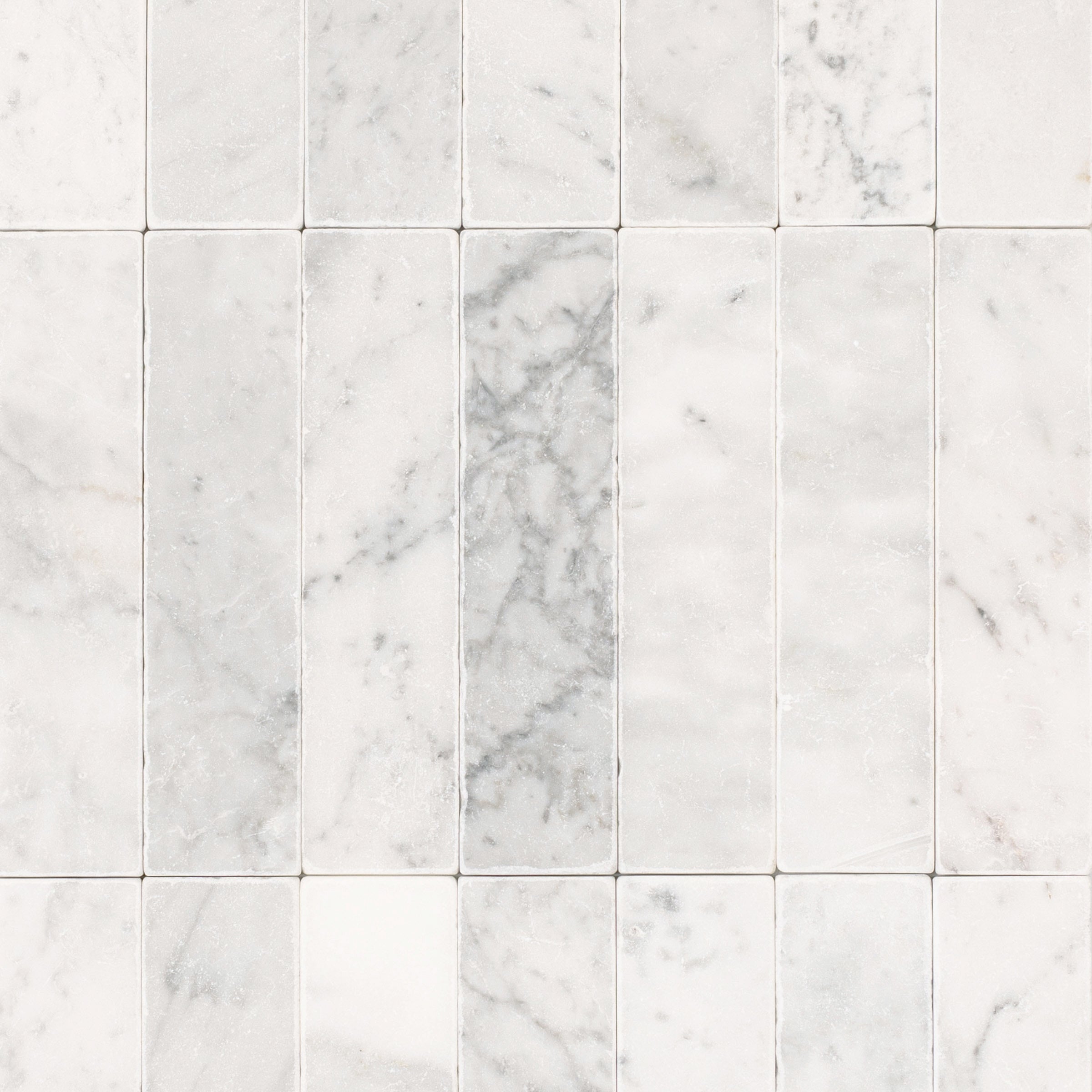 Carrara 2x8 Tumbled Marble Tile in gray and white tones from Tumbled Natural Stone Tiles Stone New Arrivals collection