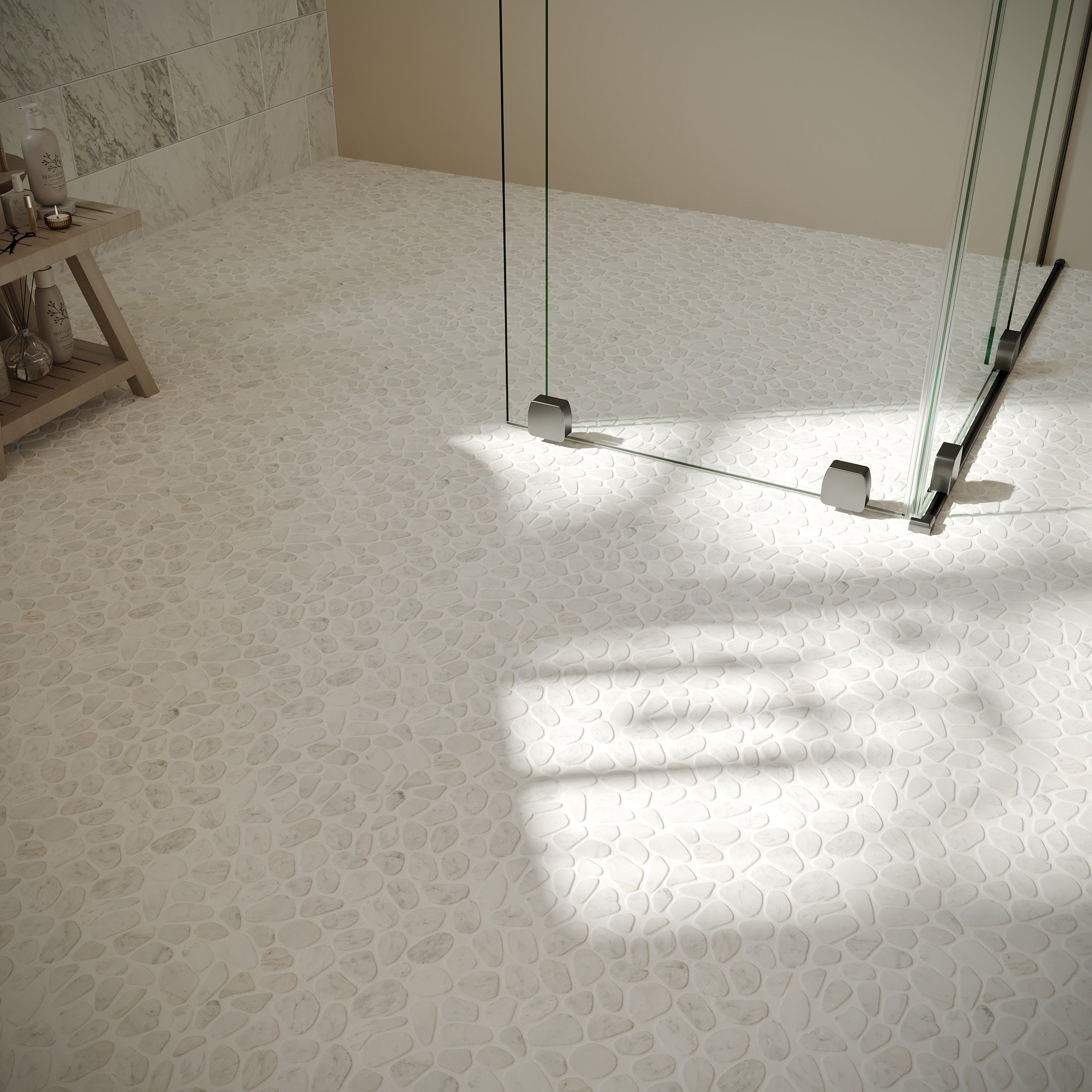 Bright bathroom floor with tumbled white pebble mosaic tiles and frameless glass shower enclosure with metal supports