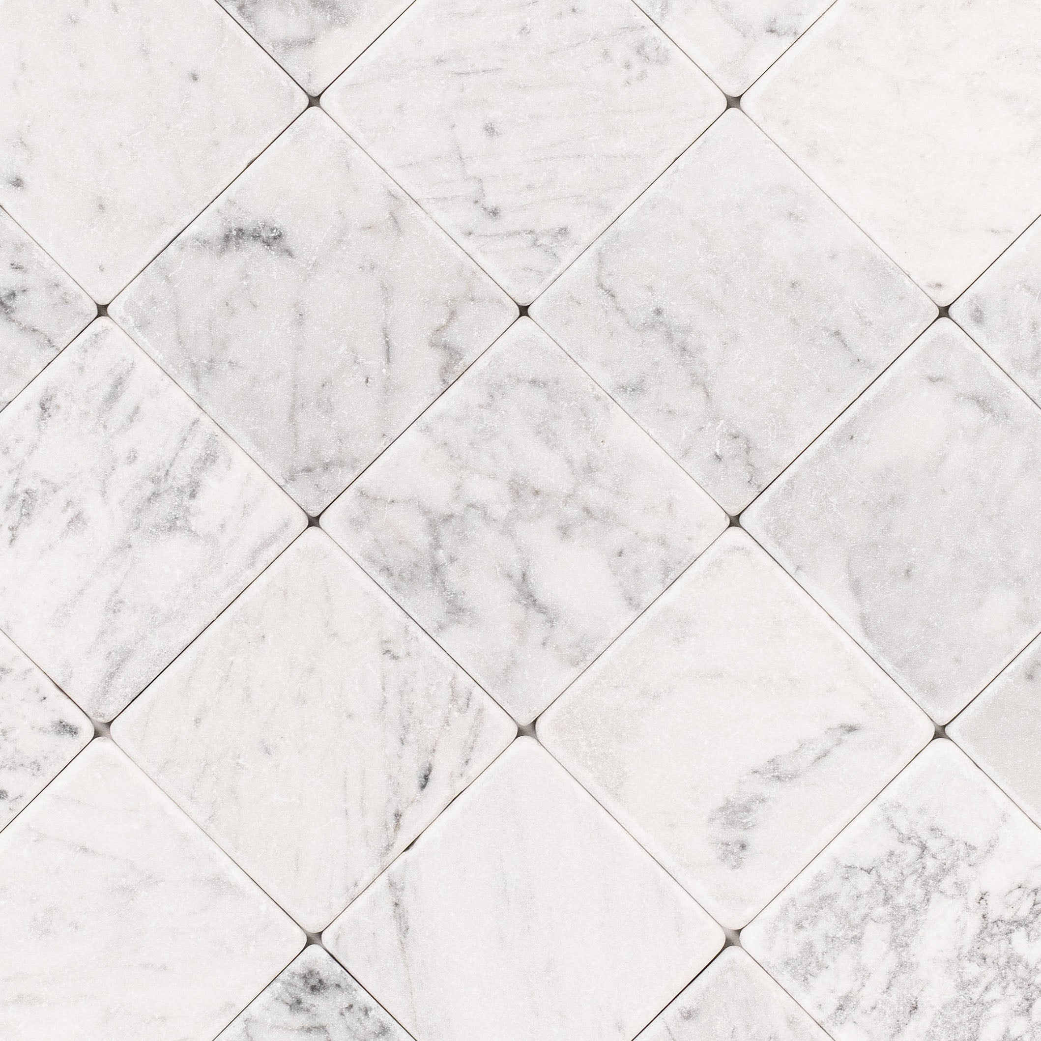 Carrara 4x4 Tumbled Marble Tile in white and gray marble with natural veining from Tumbled Natural Stone Tiles collection
