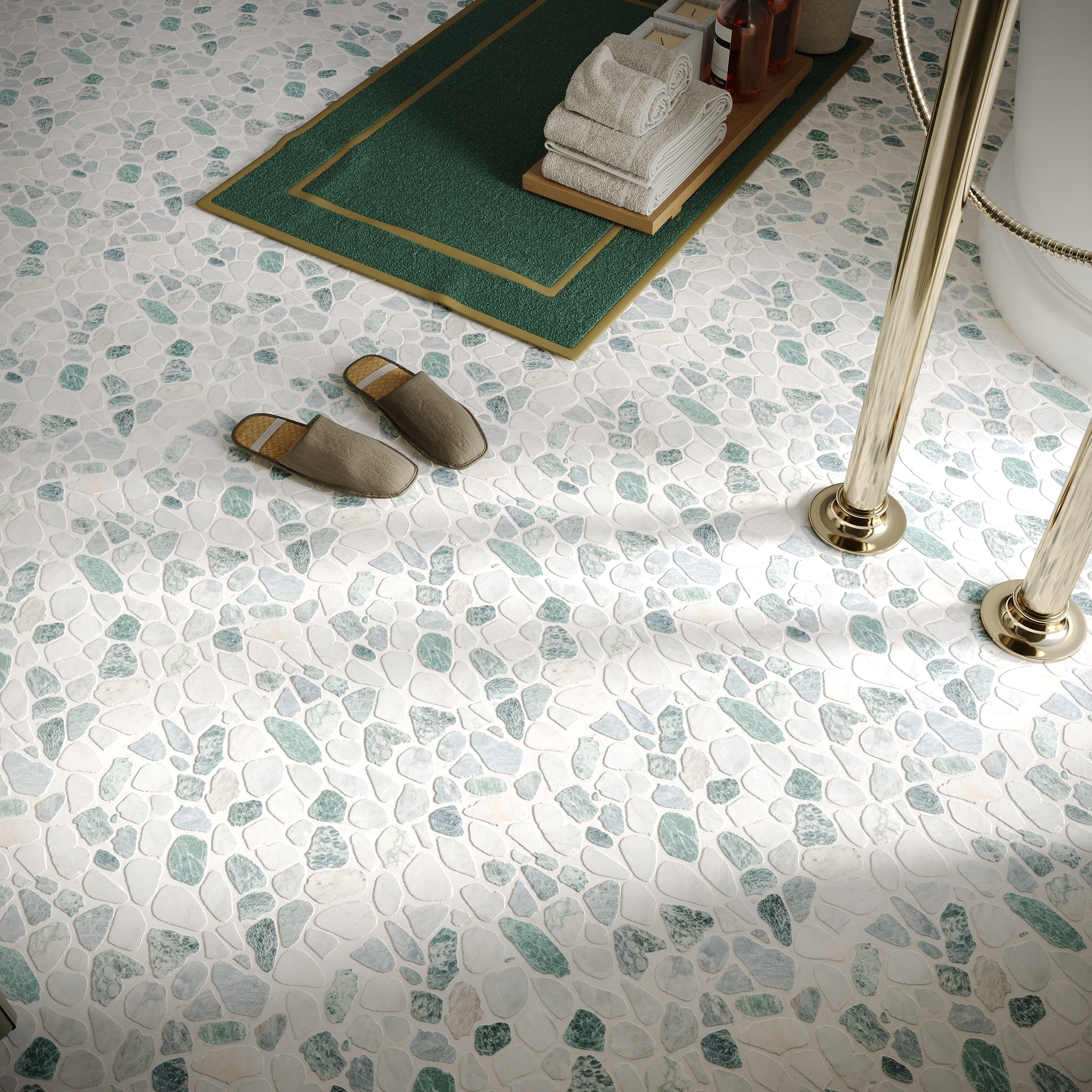 Bathroom floor with white and green pebble-style tiles, brass fixtures, green bath mat, and slippers nearby