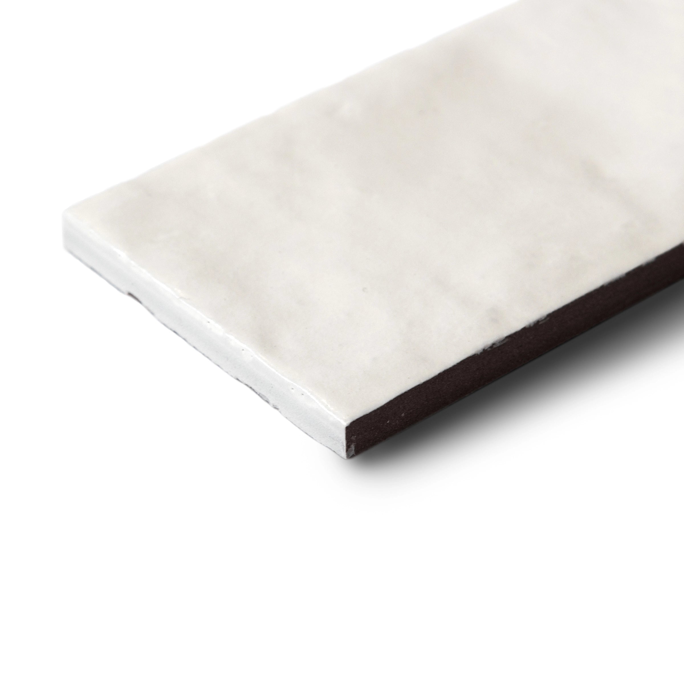 Single rectangular porcelain tile in soft off-white with a smooth matte surface and subtle natural variations