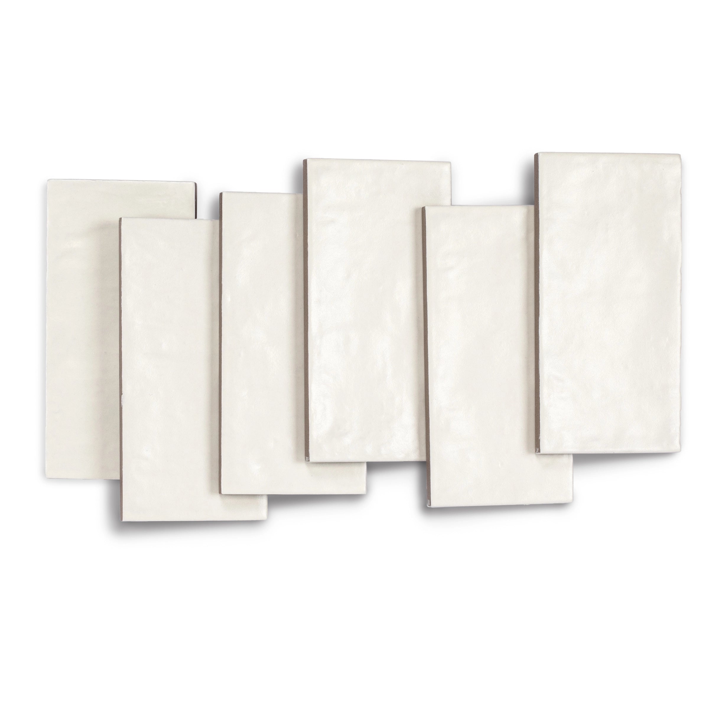 Set of seven rectangular porcelain tiles in soft chalk white with a subtle textured satin finish and gentle surface variations