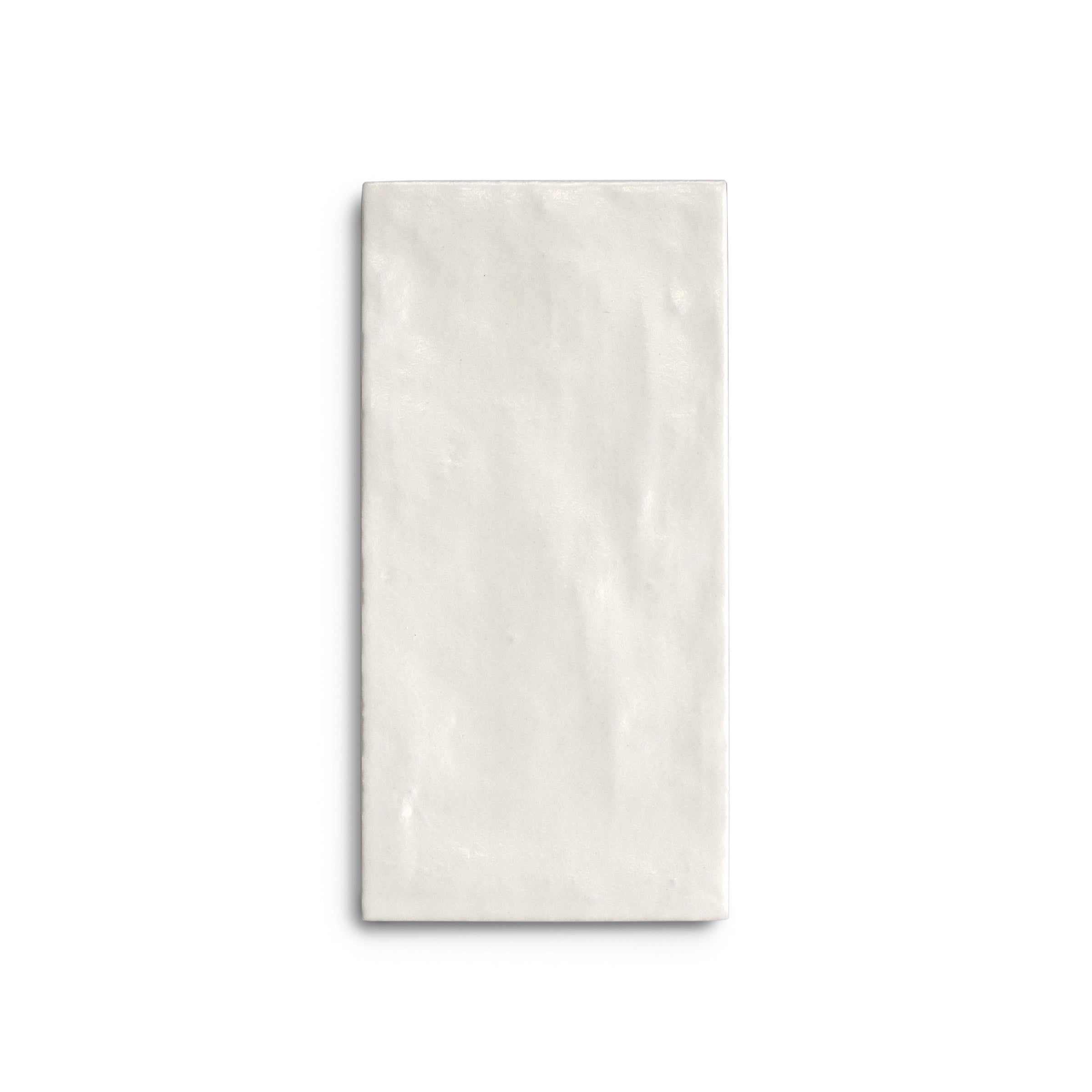 Single rectangular porcelain tile in soft chalk white with a gently textured, matte surface and subtle color variation