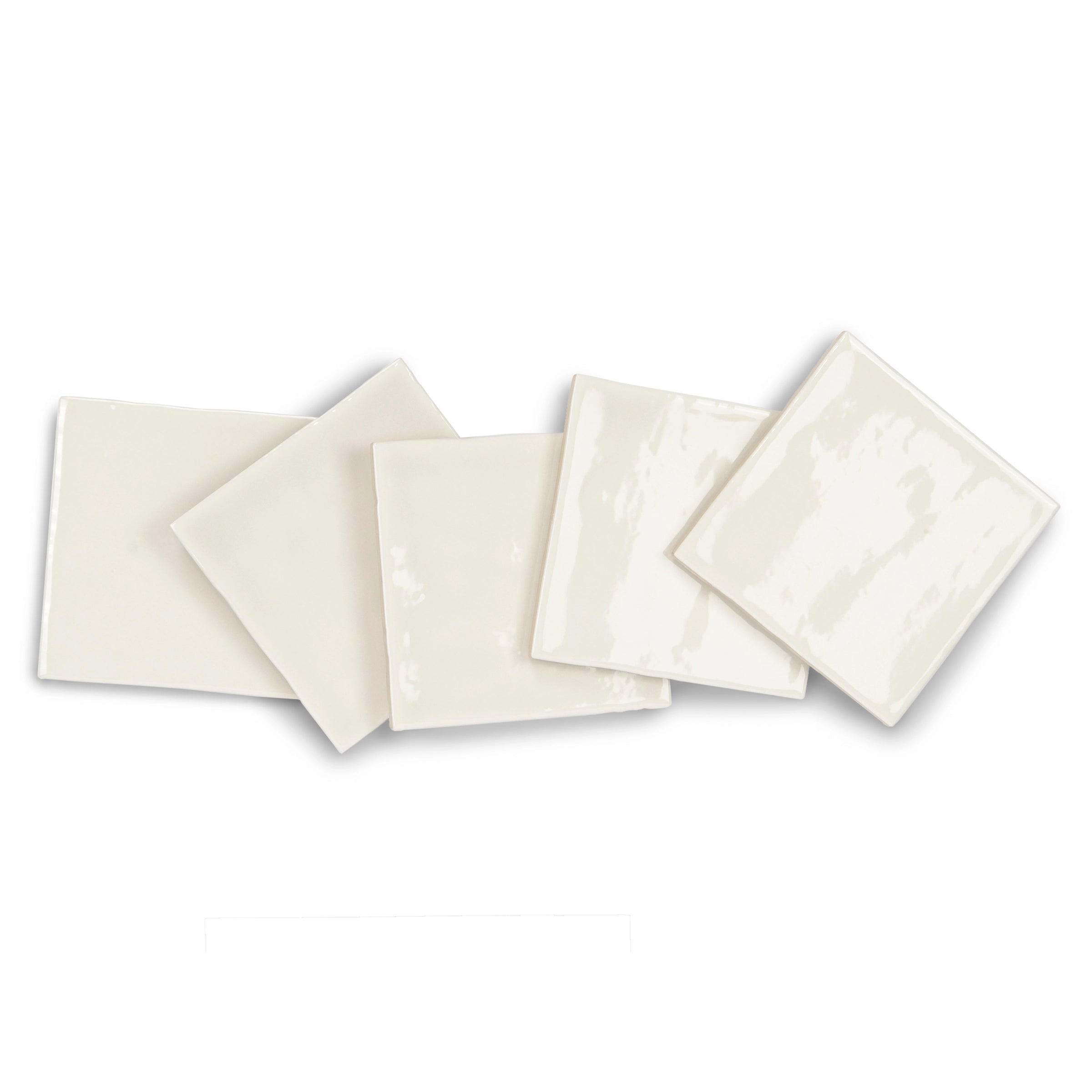 Glossy natural ceramic tiles in soft cream tones with subtle variations arranged in a casual overlapping layout