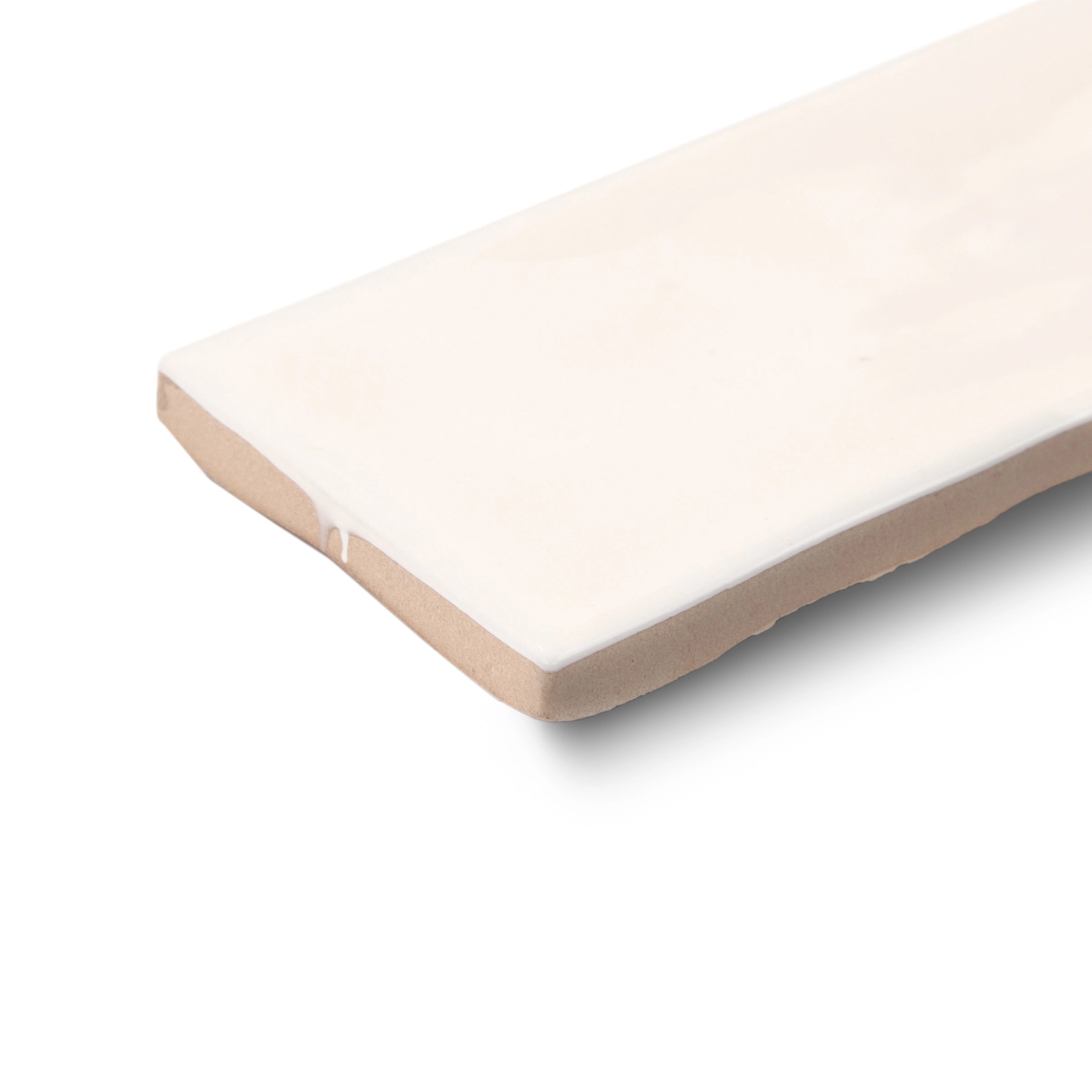 Cream ceramic tile with a glossy finish and slightly uneven edges on a white background, showcasing handcrafted detail