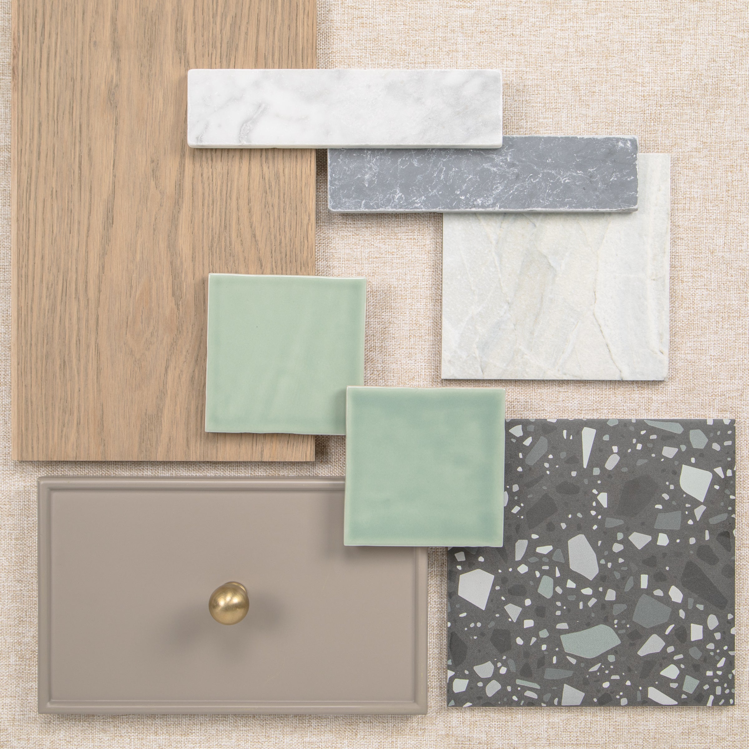 Interior material sample board with wood flooring tile swatches cabinet finish and terrazzo surface