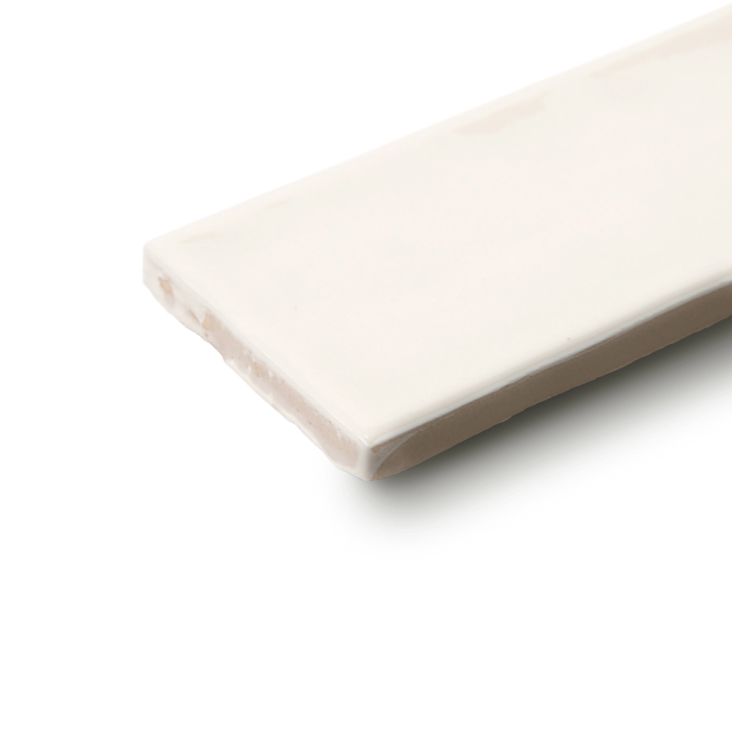 Smooth off-white ceramic tile with a slightly irregular edge and subtle matte finish on a white background