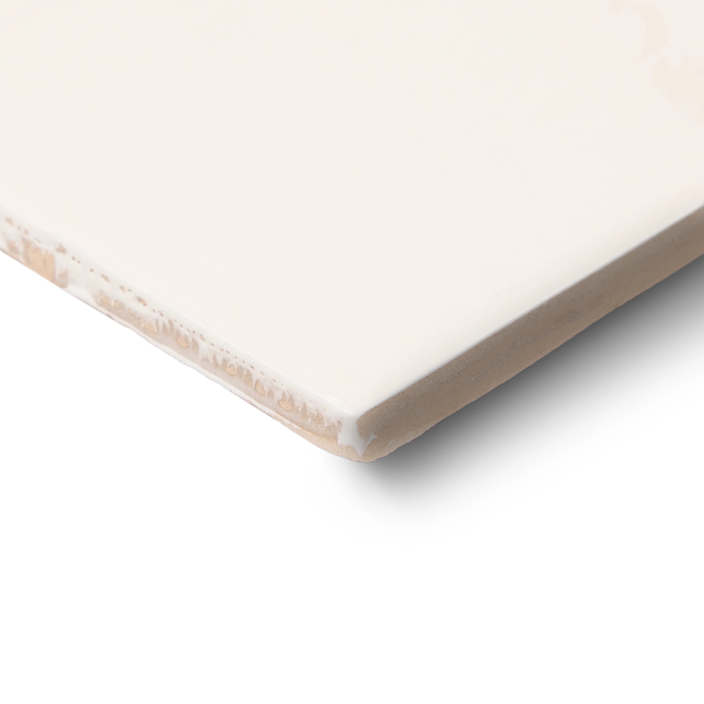 Close-up of a smooth cream ceramic tile corner with a clean, glossy surface and subtle natural edge texture