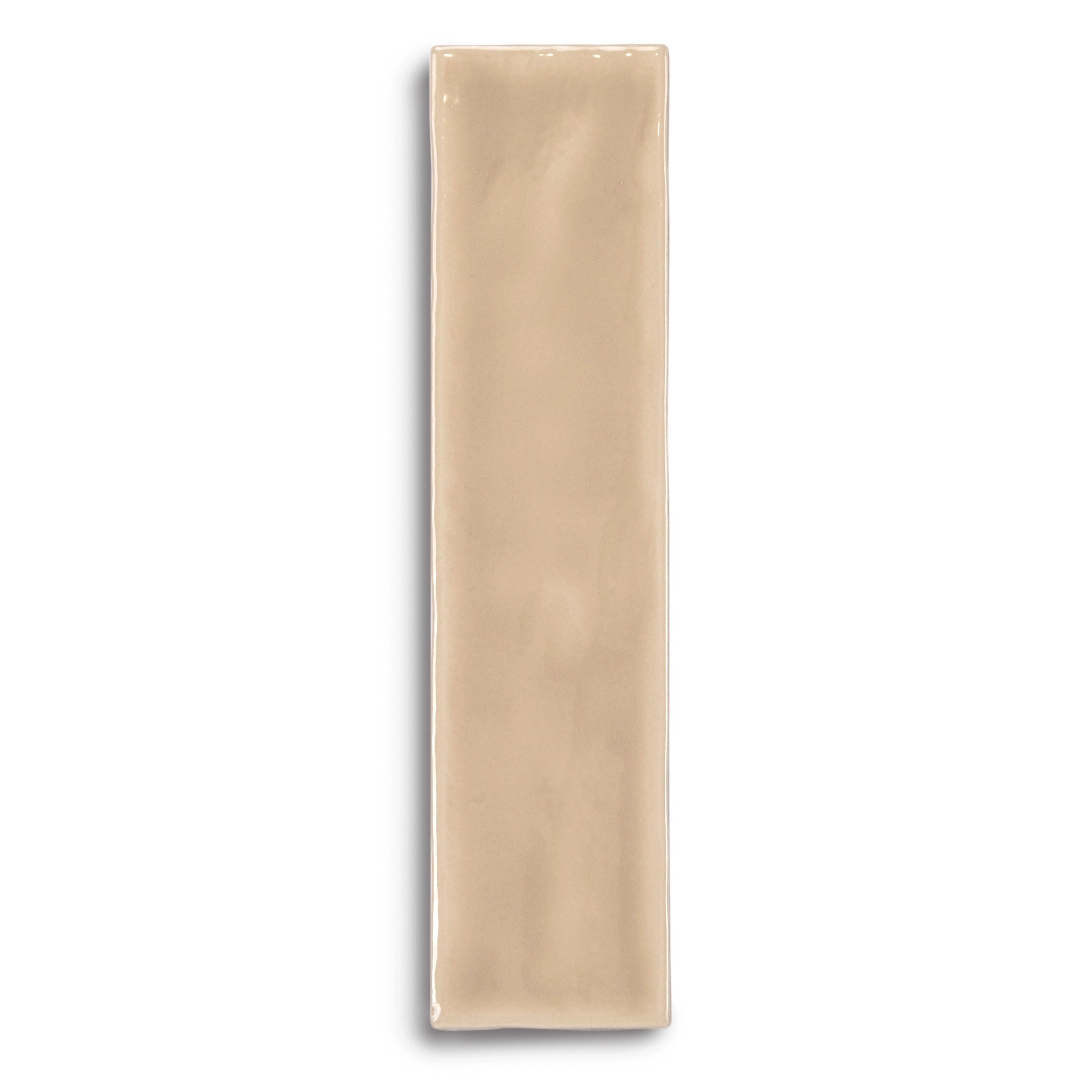 Glossy rectangular ceramic tile in warm beige with a smooth surface and slightly irregular edges on white background