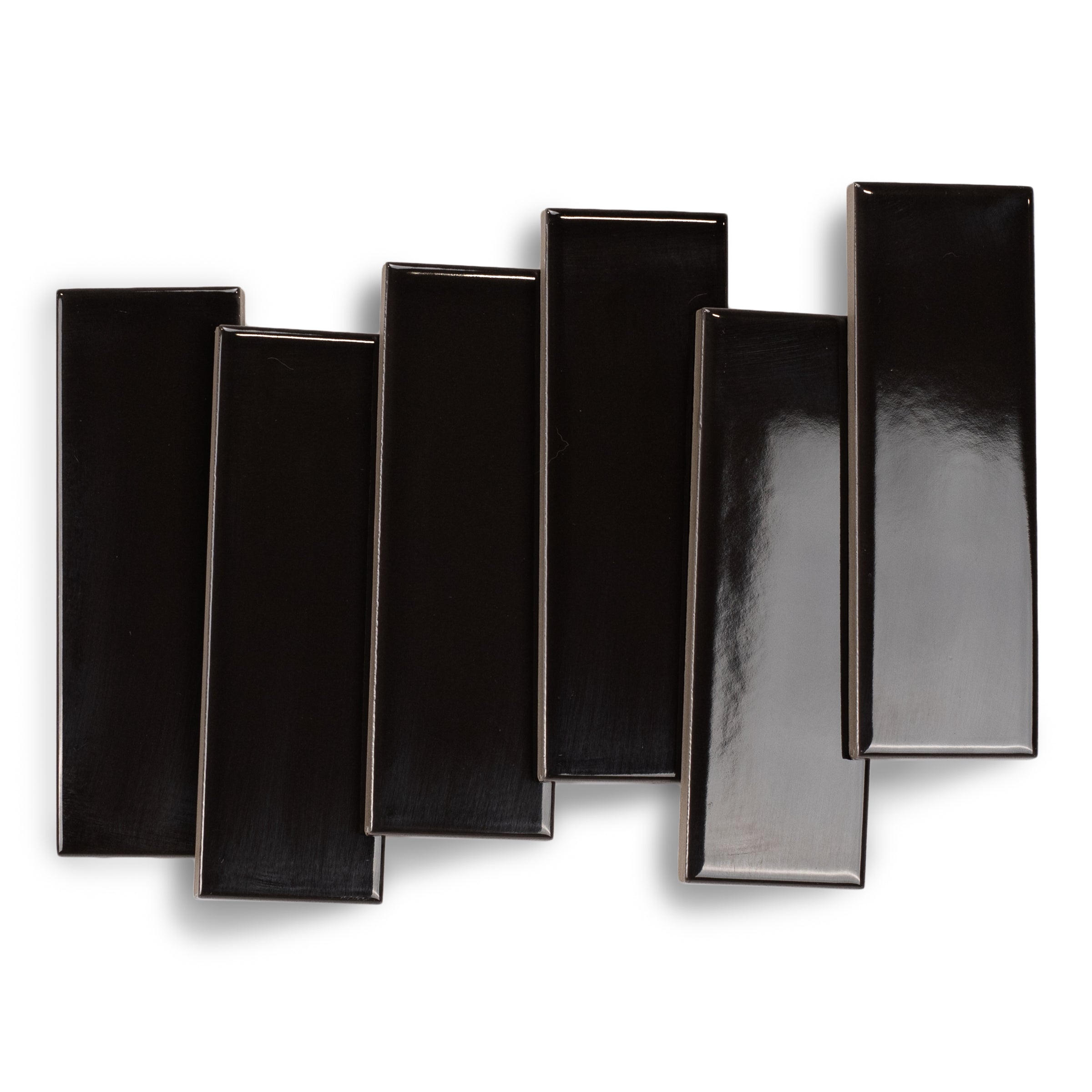 Glossy black porcelain small format tiles with smooth surfaces and clean edges arranged in a staggered pattern on white background