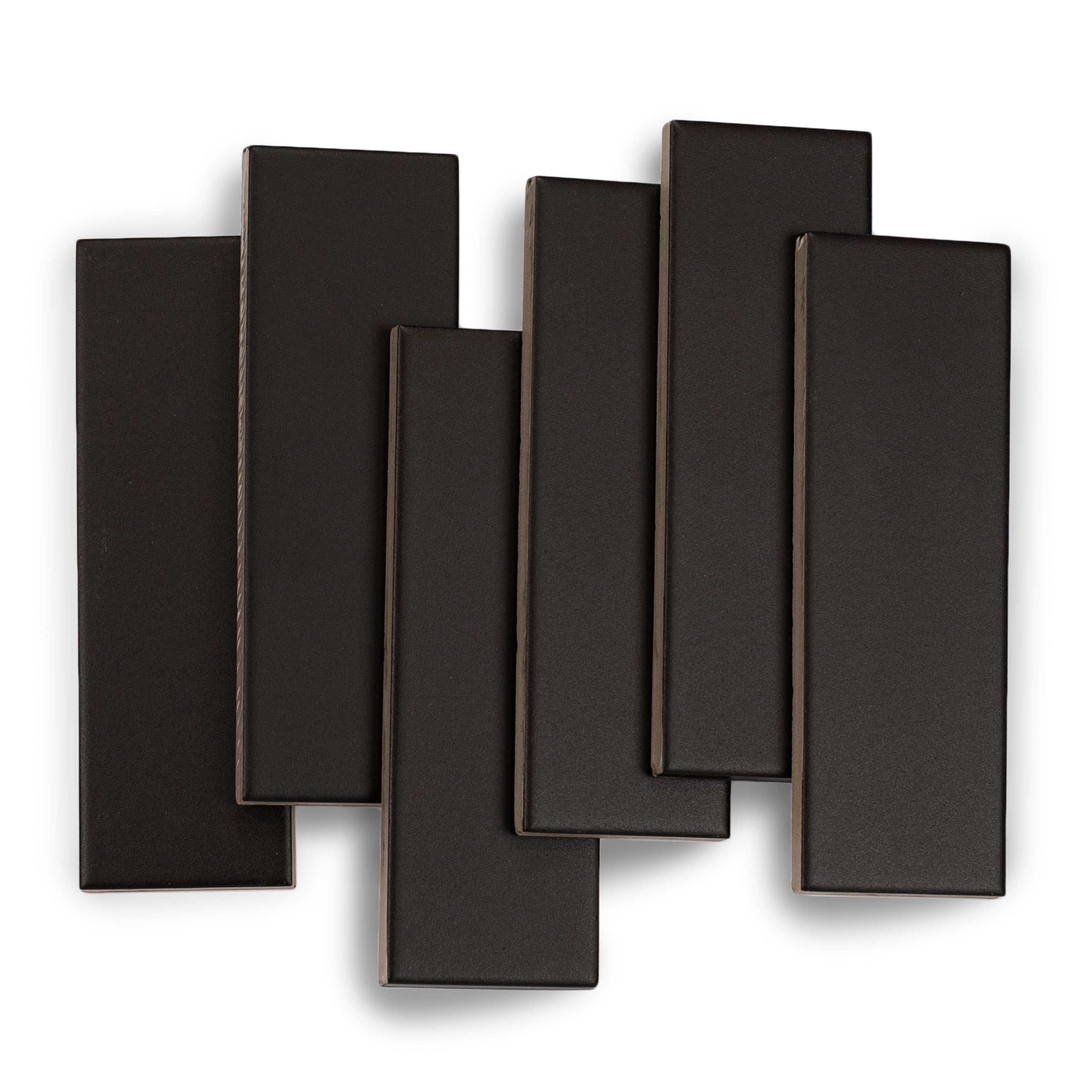 Matte black rectangular ceramic tiles with a smooth finish and slightly beveled edges arranged on white background