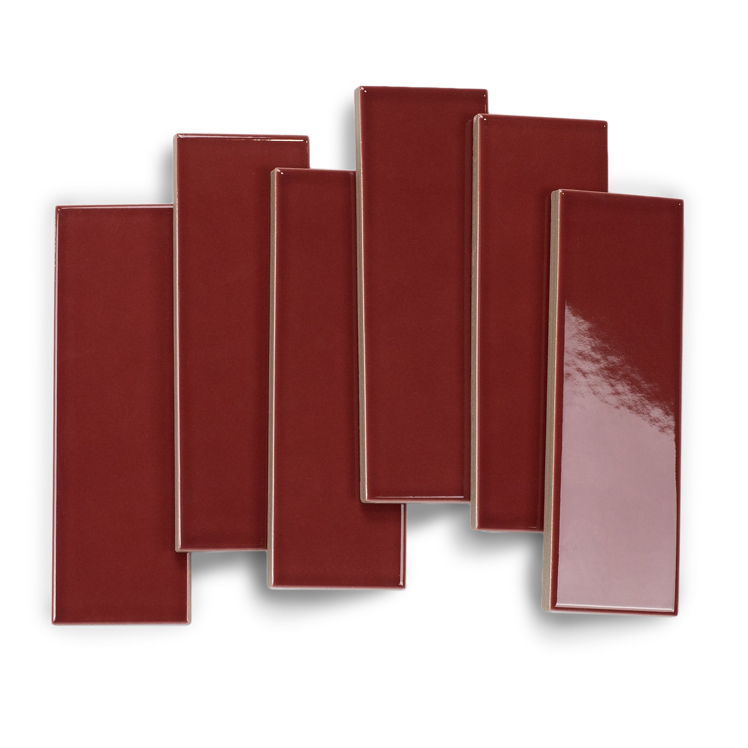 Glossy narrow rectangular porcelain tiles in rich burgundy with smooth surfaces and clean edges on white background