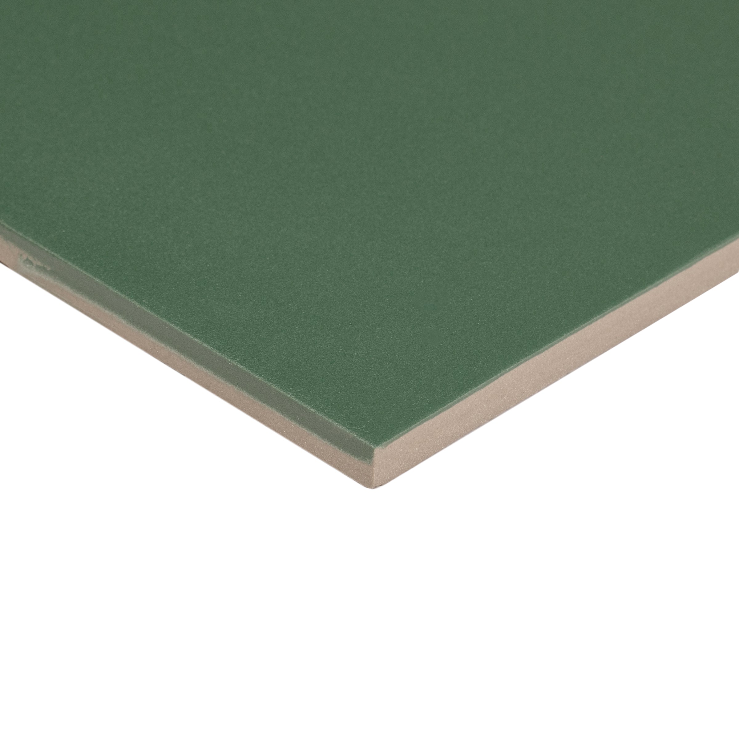 Close-up of a green ceramic tile corner showing smooth surface and beige backing material for design-oriented flooring.