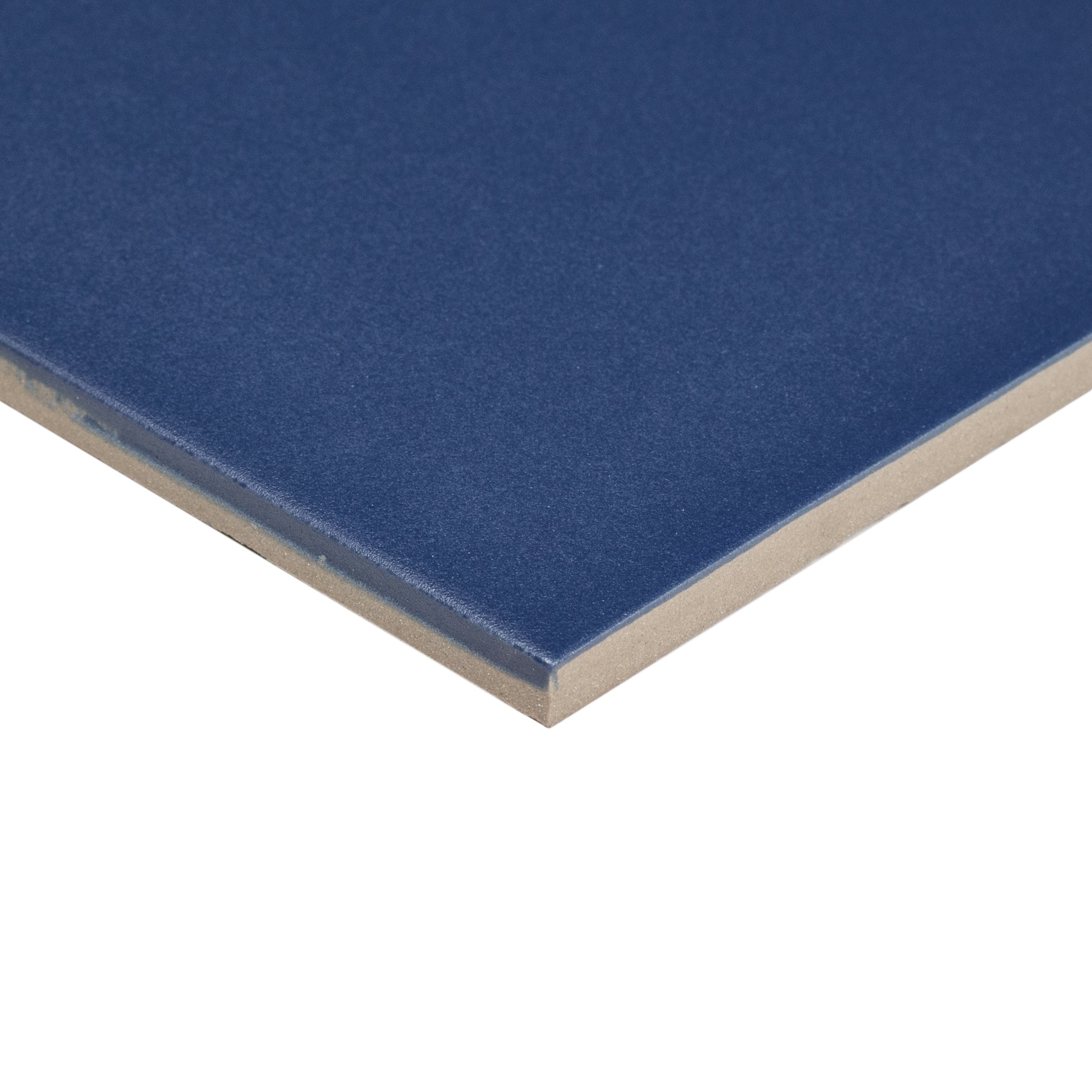 Close-up of a smooth blue ceramic tile corner showcasing its thickness and matte finish.