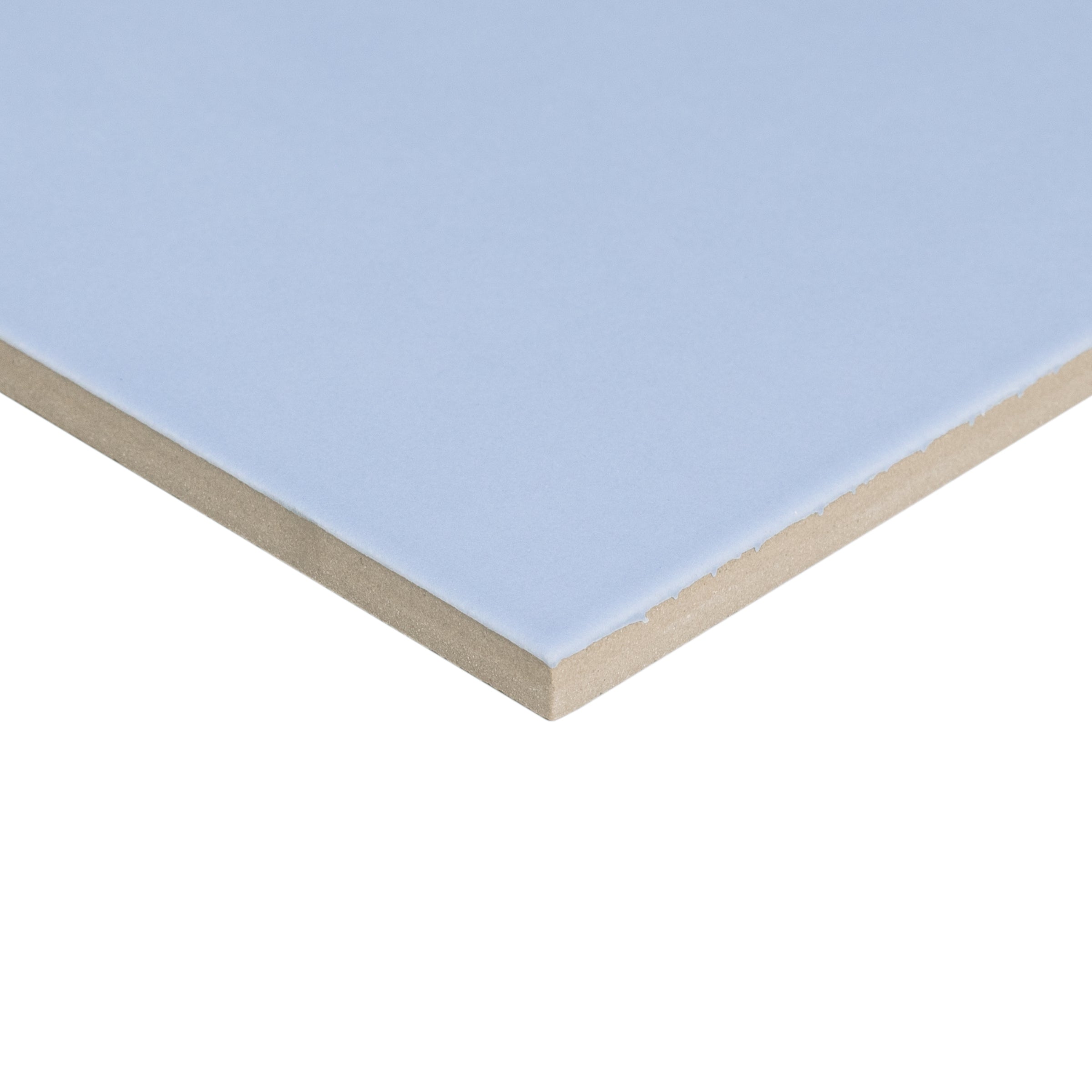 Close-up of a light blue ceramic tile with a smooth surface and beige backing edge visible against a white background