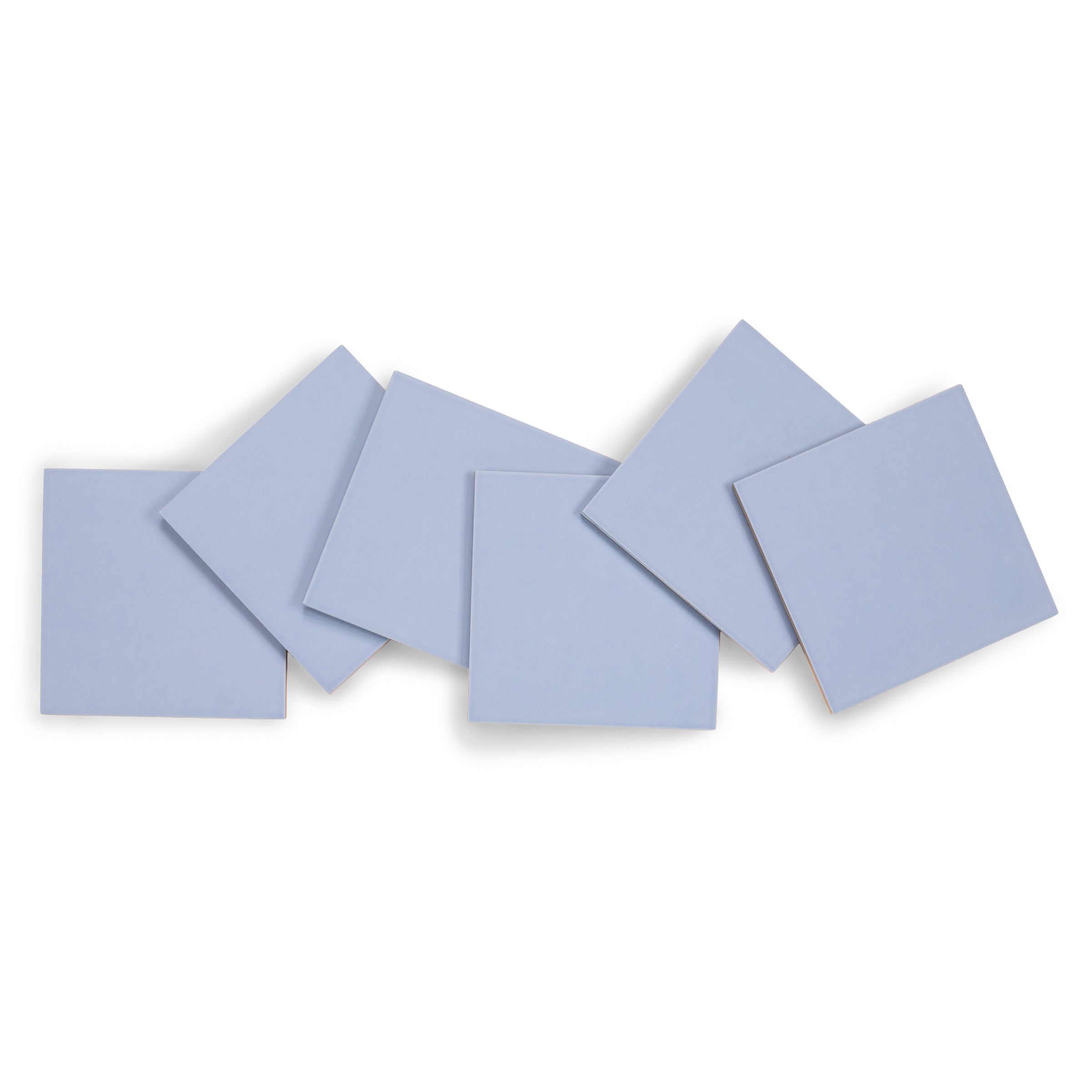 Stack of six light blue ceramic tiles arranged with slight overlapping on a white background