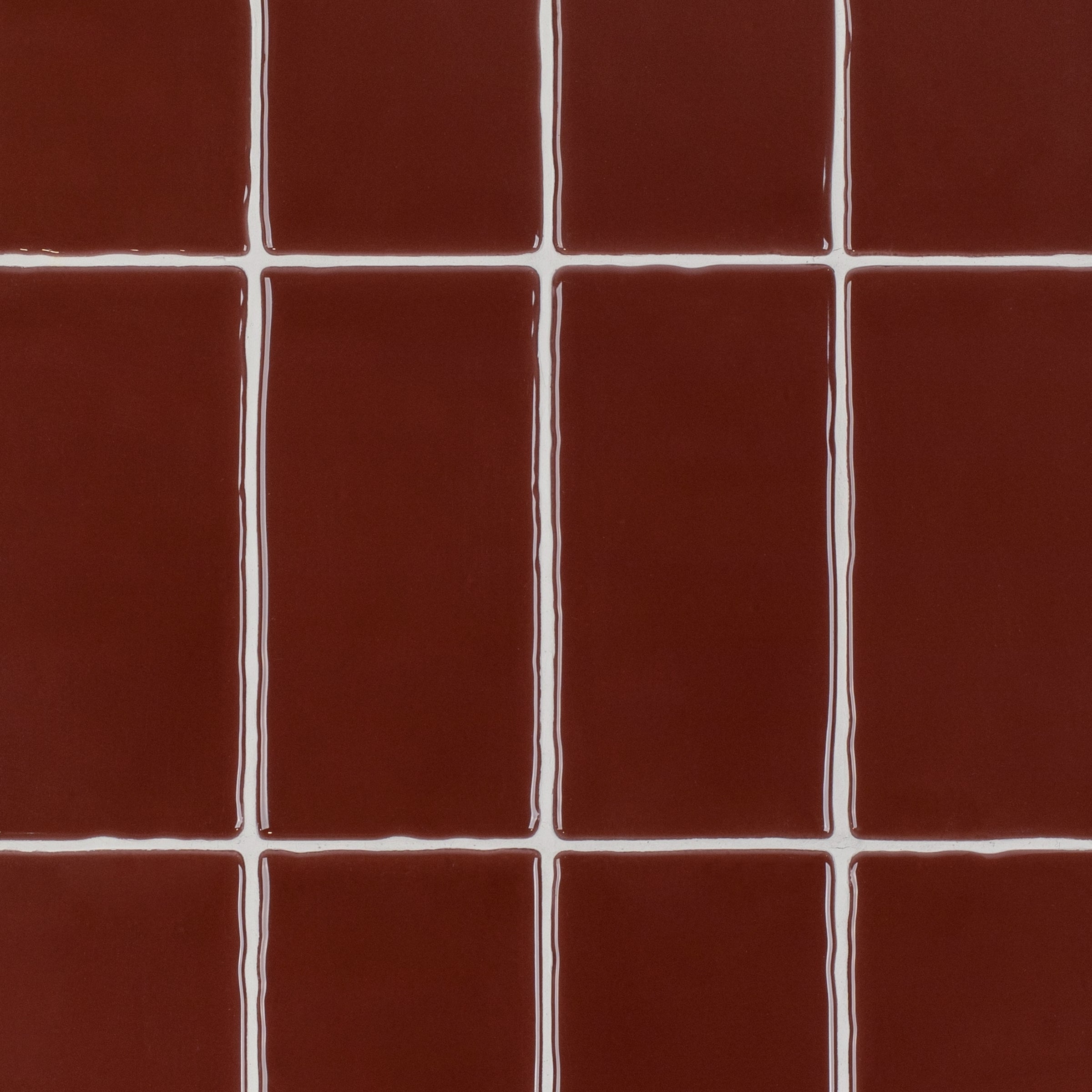 Crimson 3x6 Glossy Ceramic Tile in deep red with a glossy finish and subtle undulating surface from Seville Small Format Tiles collection