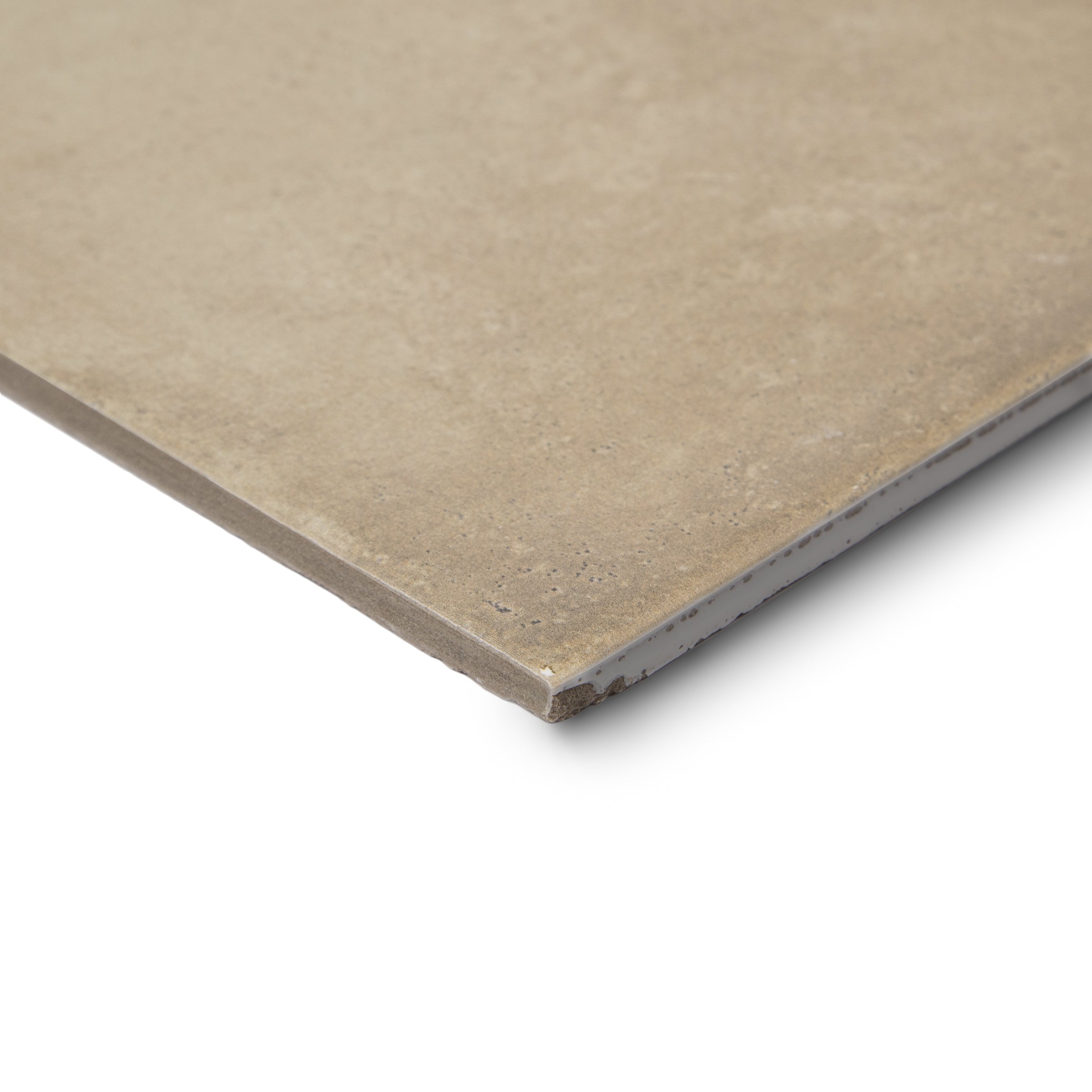 Close-up of a single beige ceramic tile corner on a white background showing surface texture and edge details