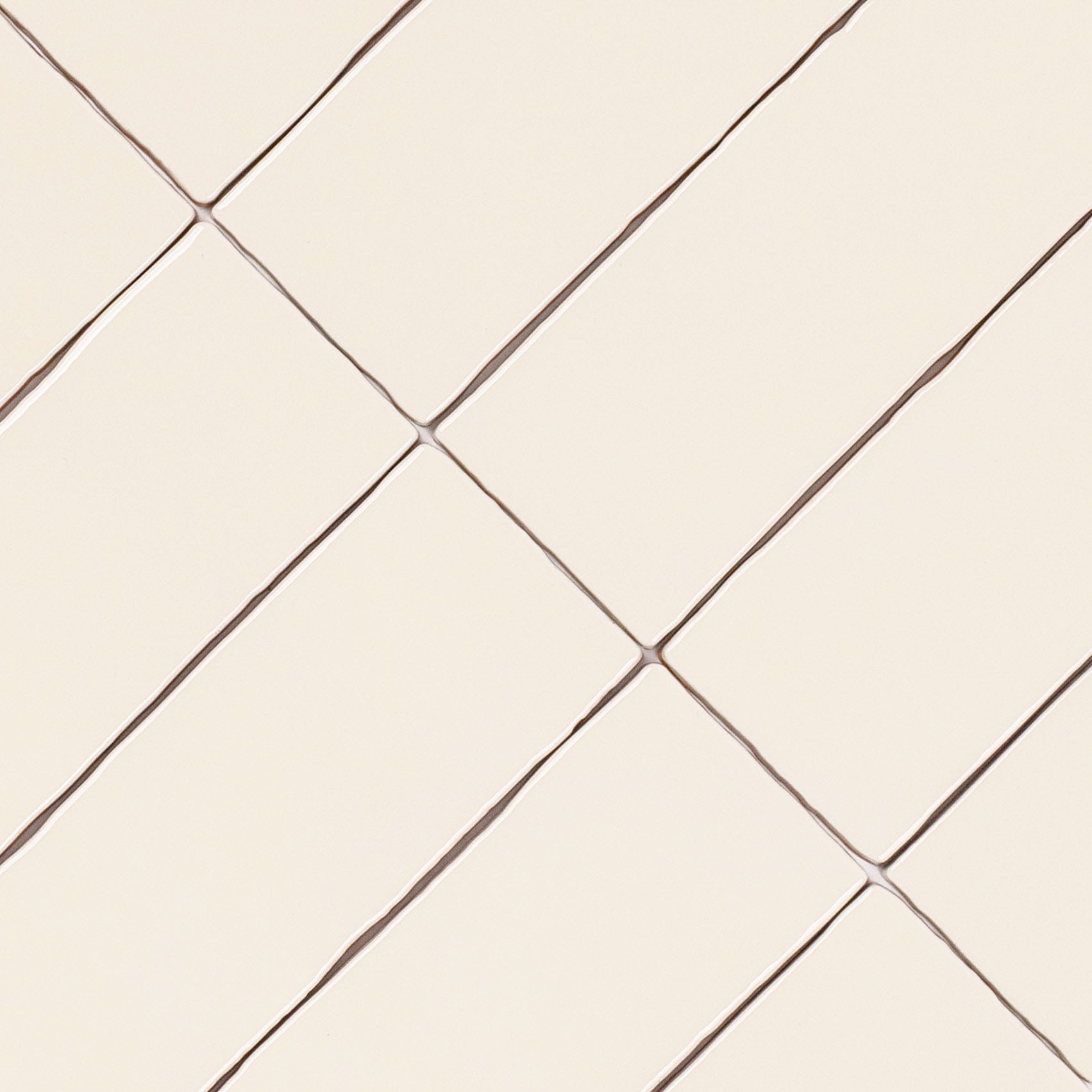 Dark White 3x12 Glossy Ceramic Tile in warm beige with slight surface waves from Seville Glossy Ceramic Tiles collection