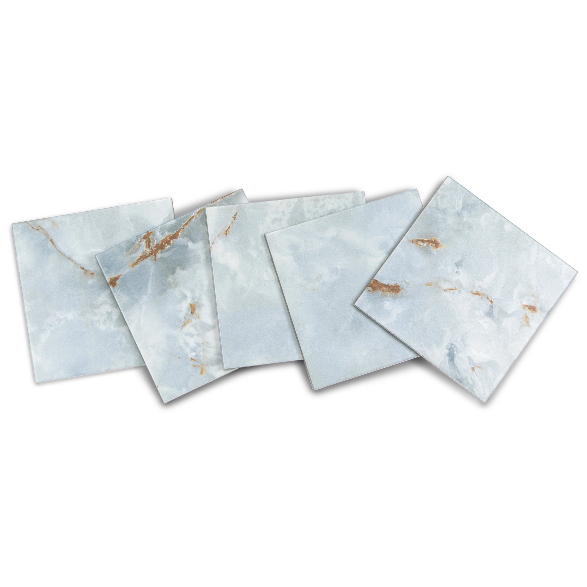 Arrangement of pale blue-gray ceramic tiles with soft white and warm amber veining on a white background