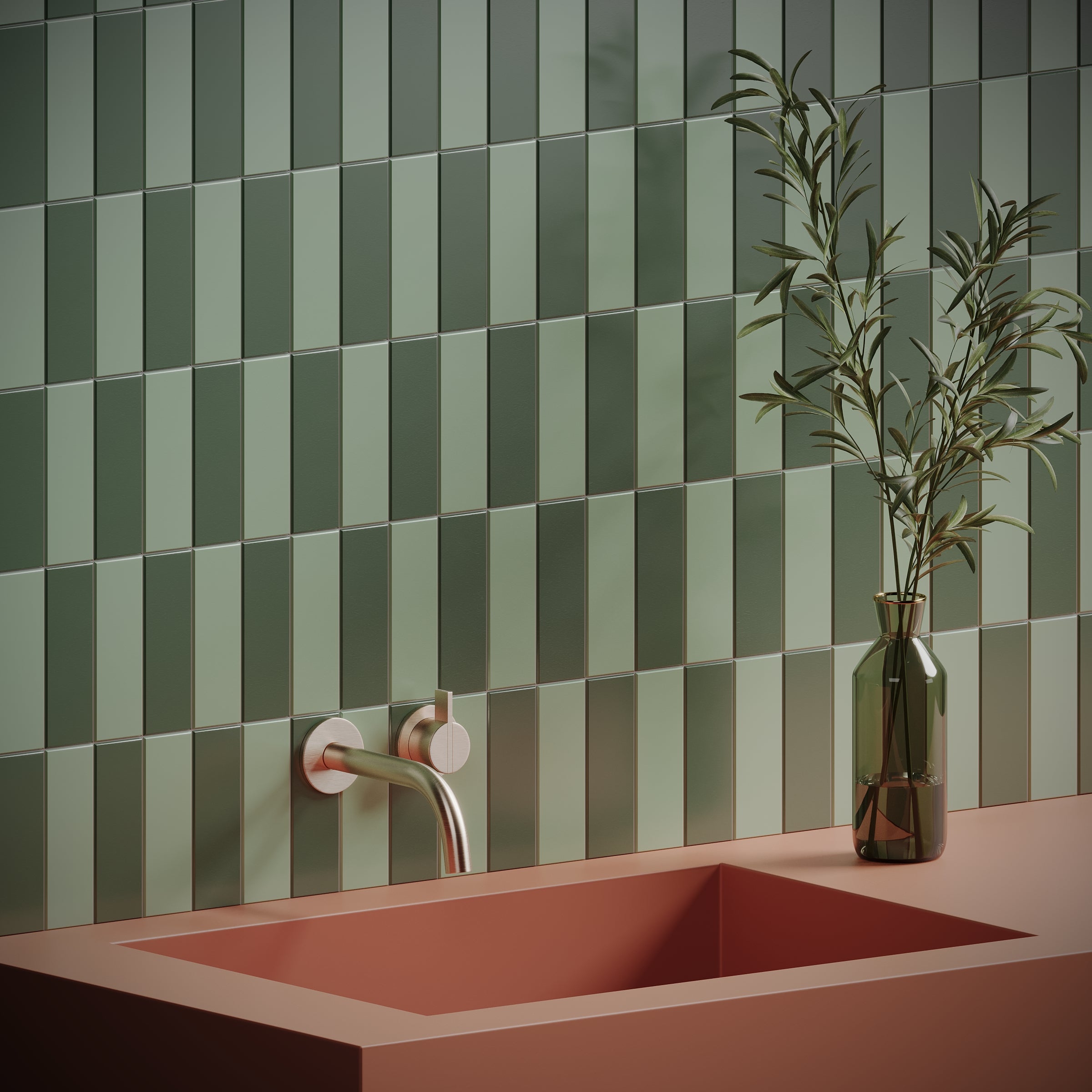 Green rectangular ceramic tiles in alternating shades on wall above matte pink sink with modern faucet and green vase