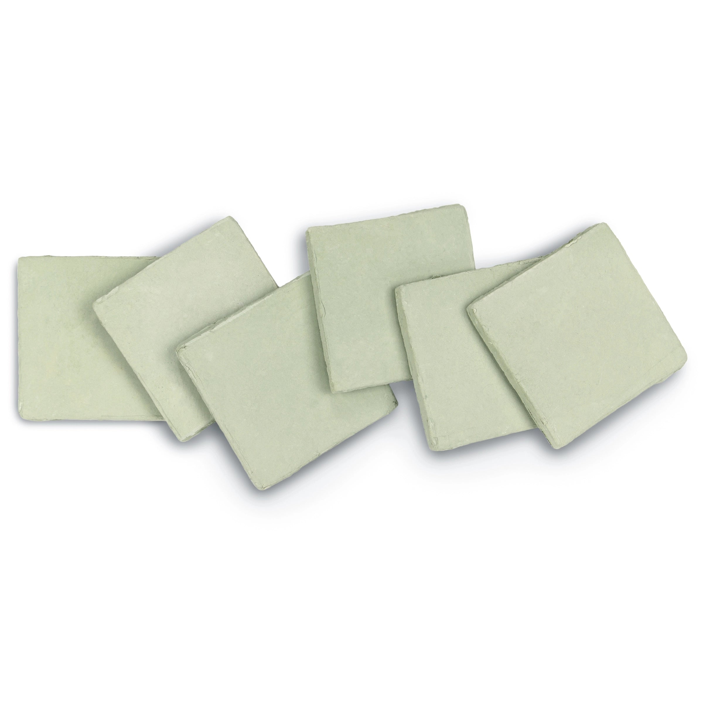 Set of six pale green ceramic tiles with uneven edges and a soft matte surface arranged loosely on white background