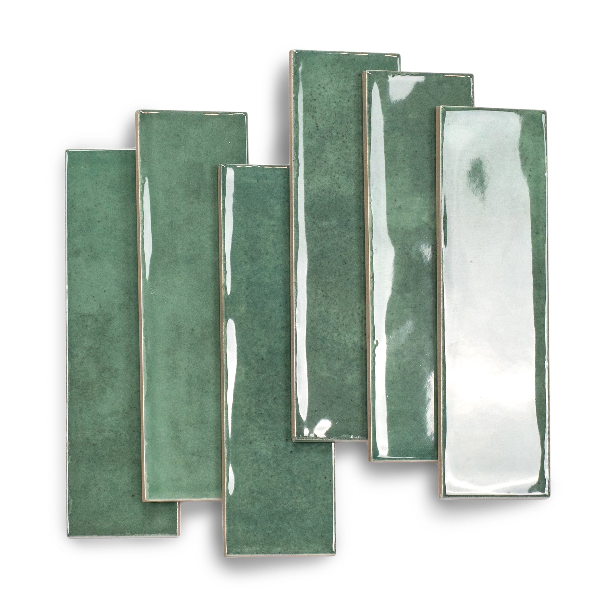 Glossy green ceramic tiles in varied shades arranged in an overlapping pattern on a white background
