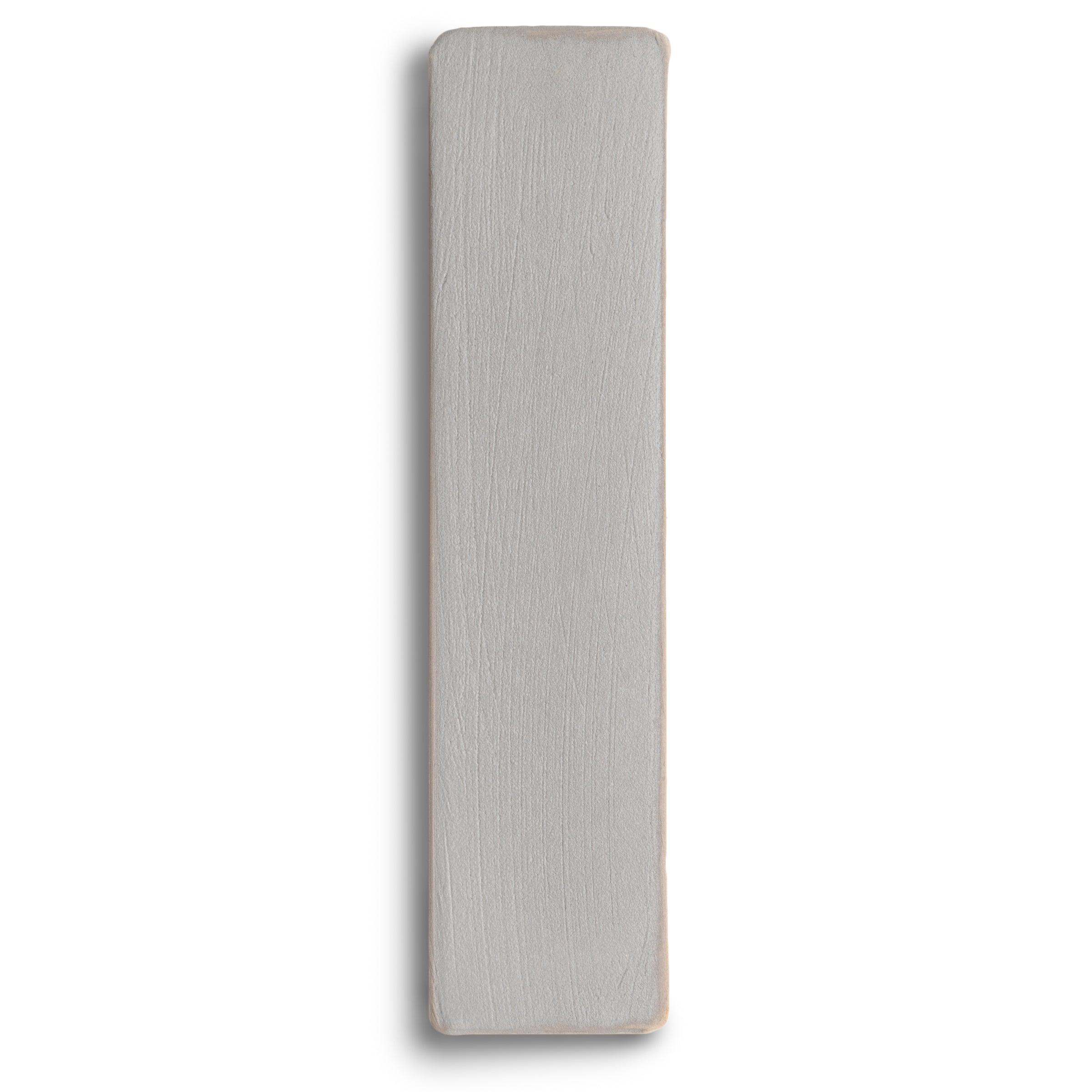 Long narrow ceramic tile in soft grey with subtle texture and rounded edges on a white background