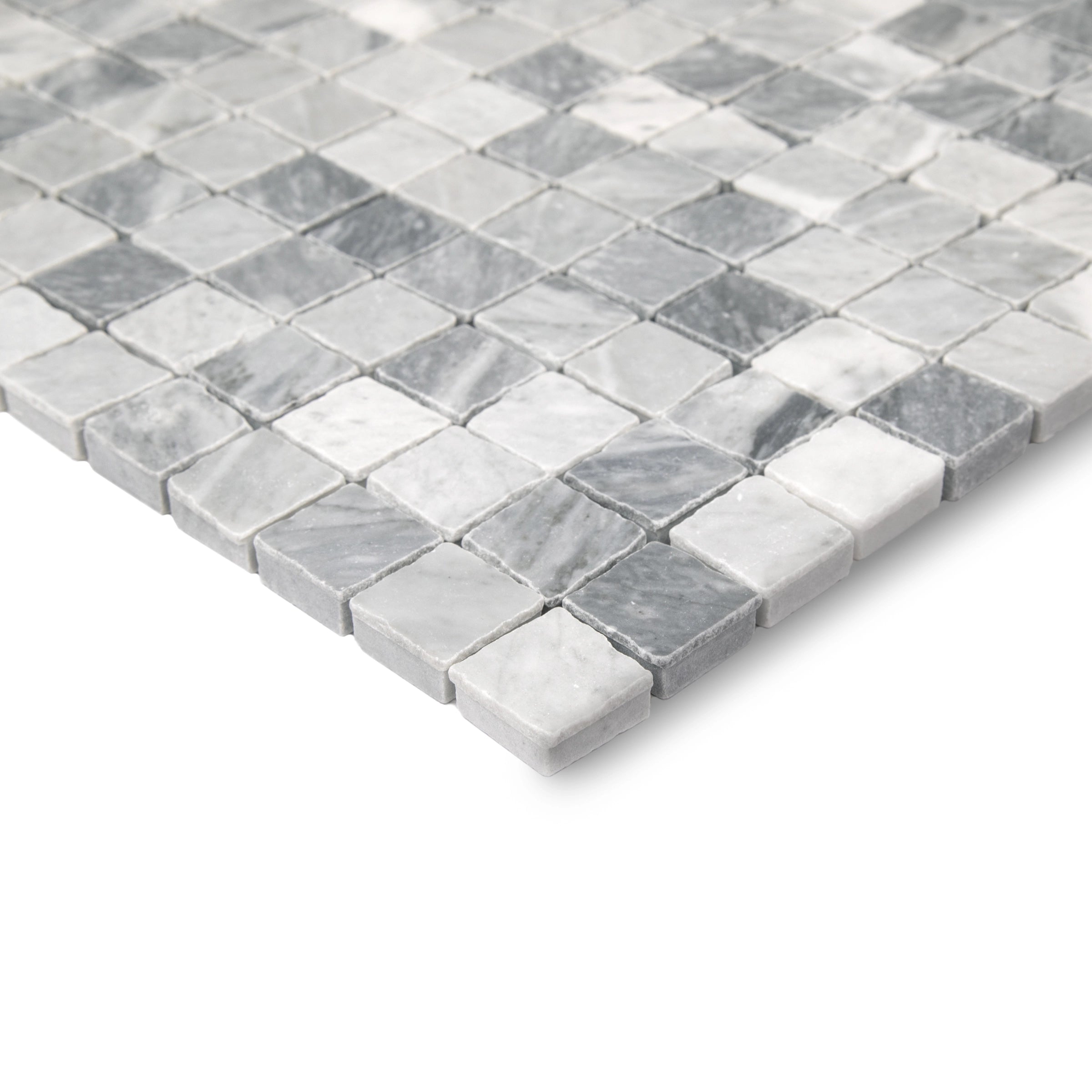 Close-up of hand-chipped natural stone mosaic tiles in varied shades of soft gray and white arranged in a grid pattern