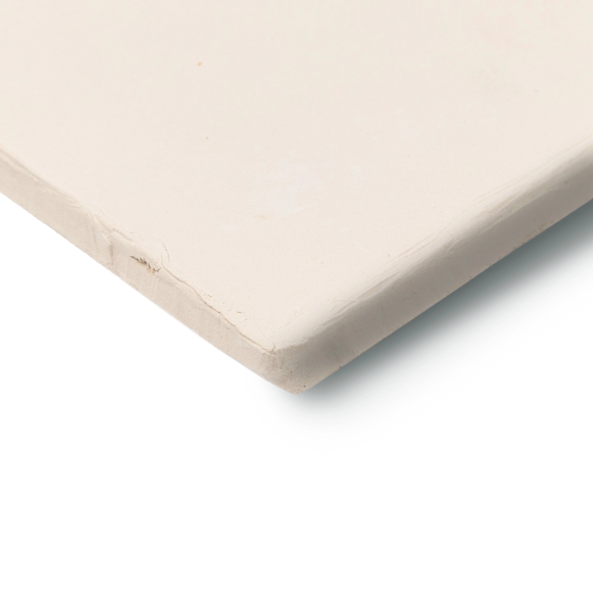 Close-up of a smooth, matte ceramic tile in soft ivory with slightly rounded edges on a white background