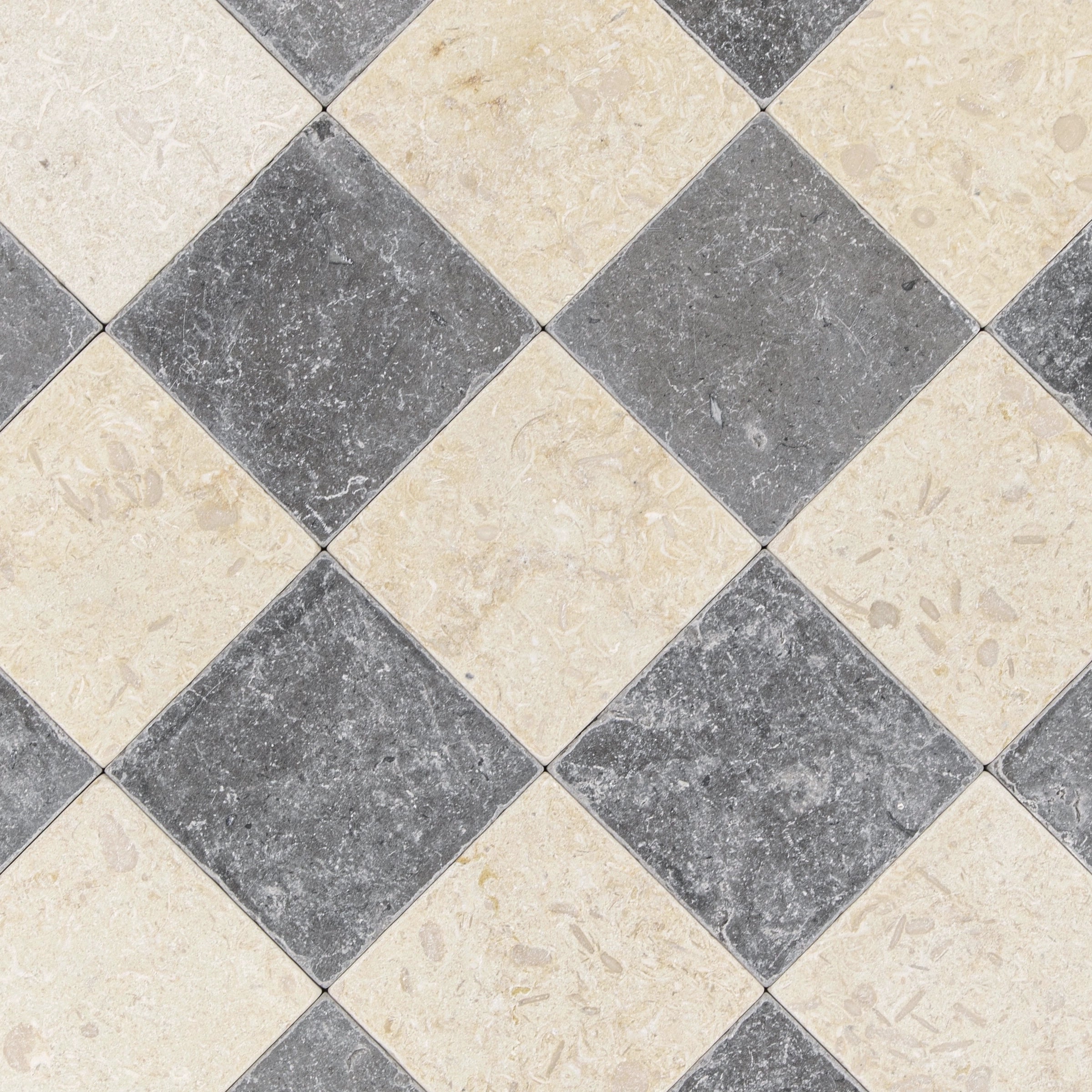 Checkerboard arrangement of square stone tiles in muted gray and beige with natural textured and mineral surface details