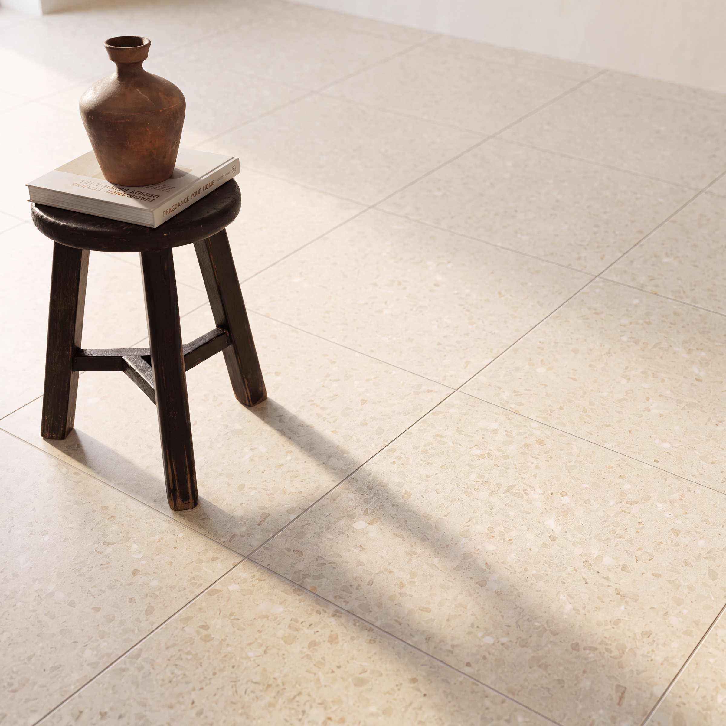 Brown vase and books on a dark wooden stool over a beige tiled floor with sunlight and shadows