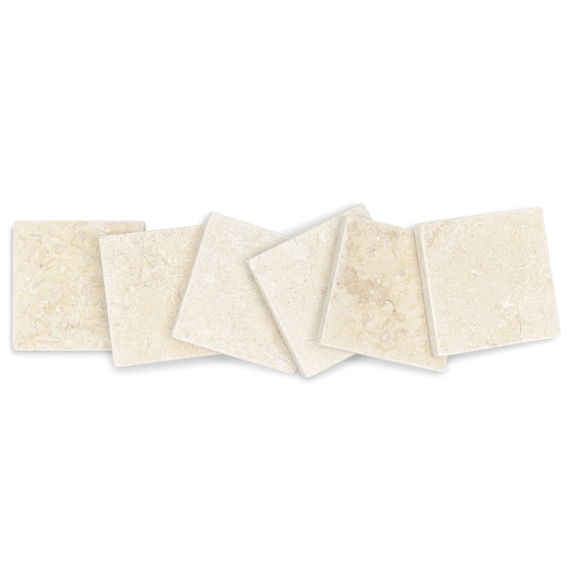 Six small square stone tiles in soft cream tones with a lightly textured surface arranged overlapping on white background