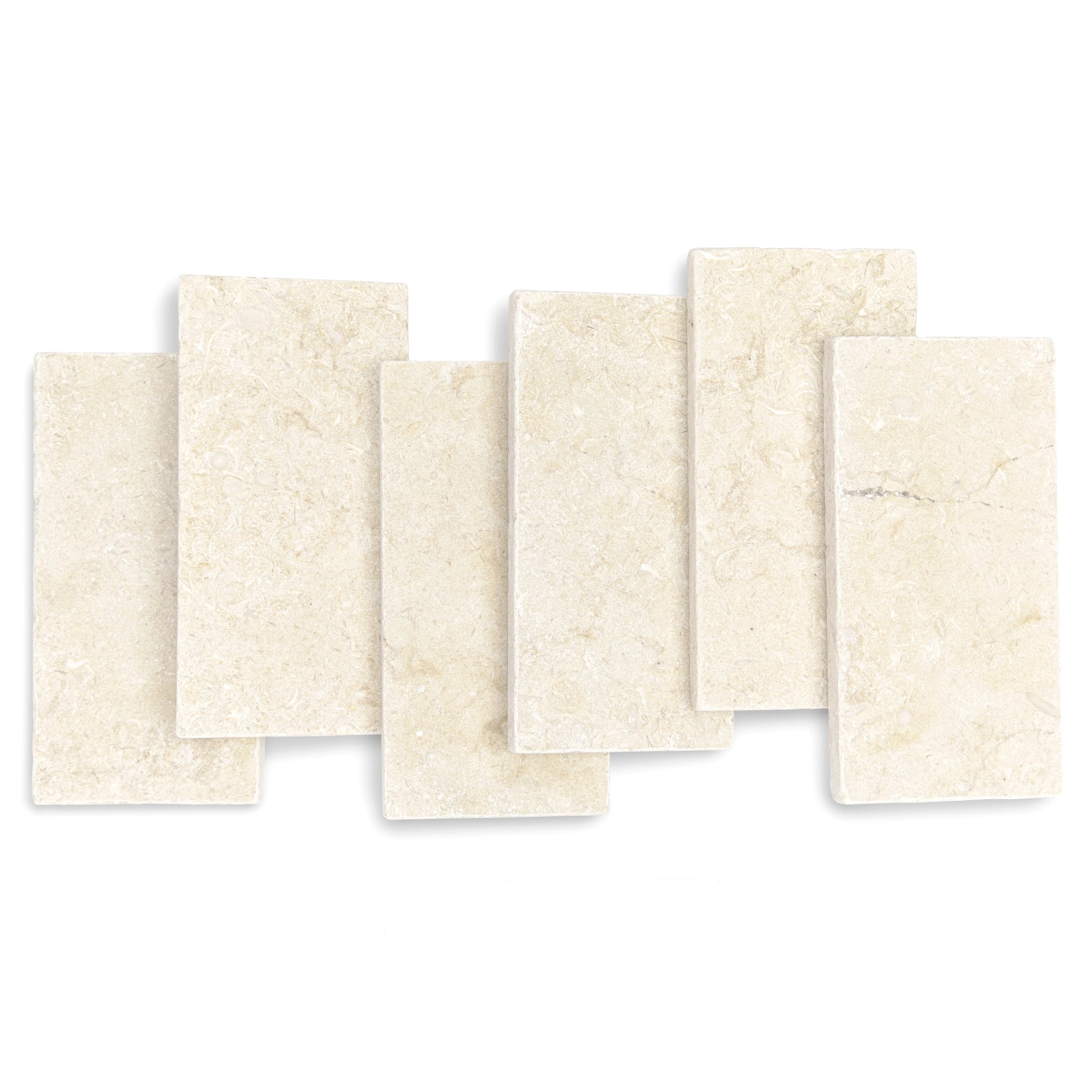 Seven rectangular cream-colored stone tiles with subtle natural texture and soft mineral veining arranged overlapping
