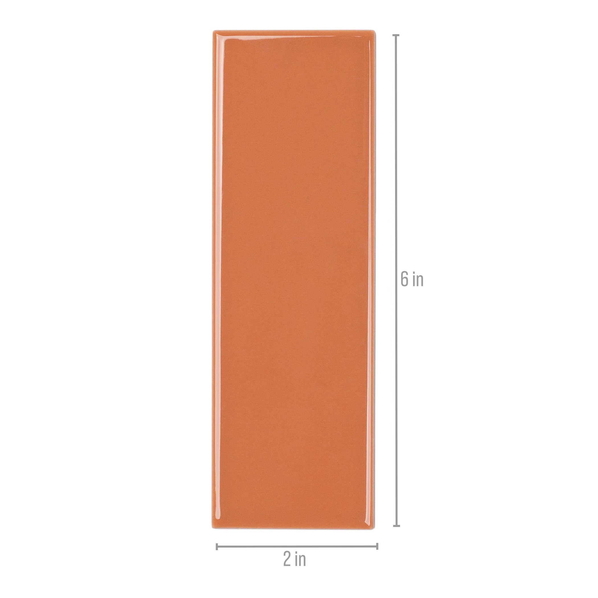 Glossy orange rectangular porcelain tile with smooth surface and rounded edges measuring approximately 2 by 6 inches