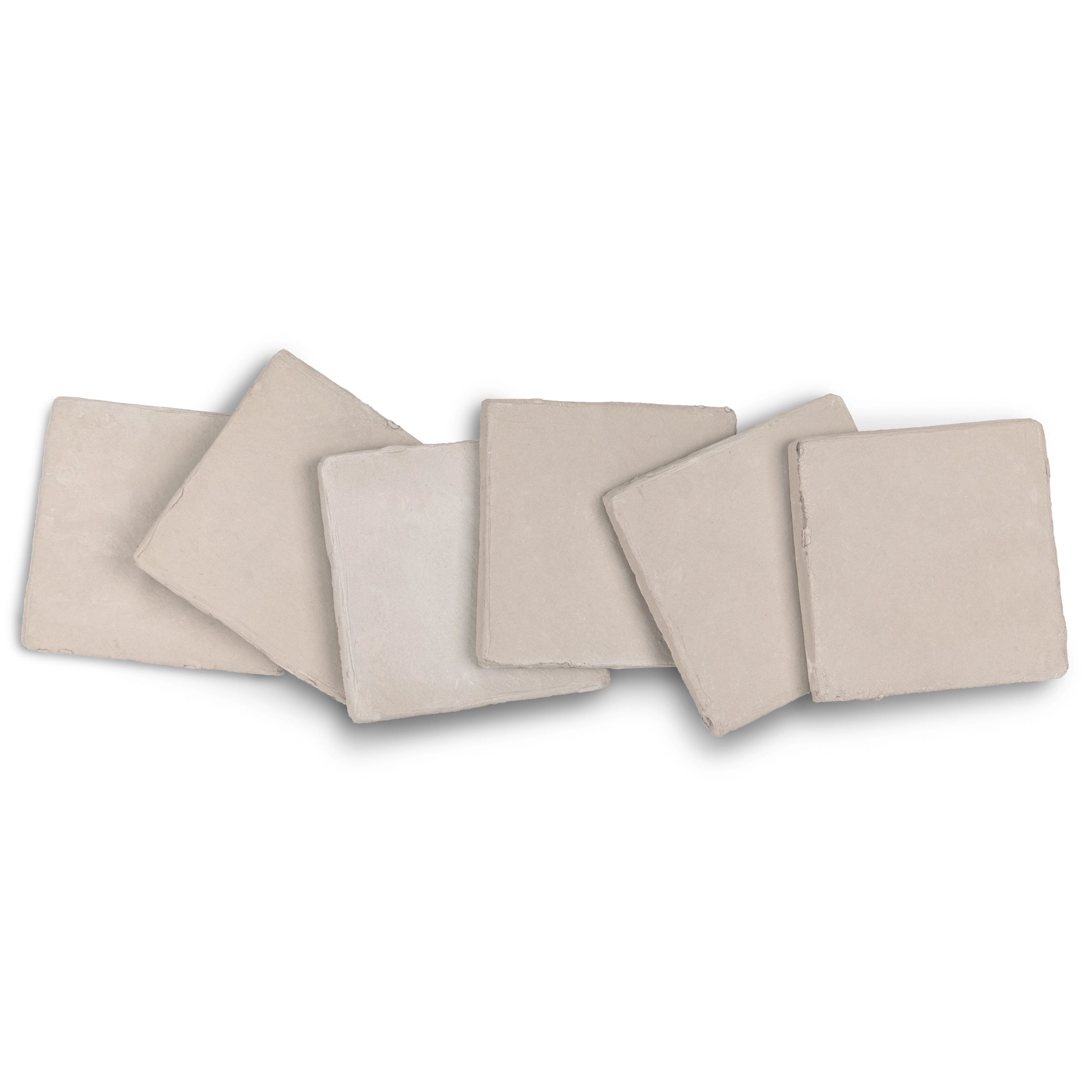 Six light pewter small format ceramic tiles with uneven edges arranged loosely on a white background