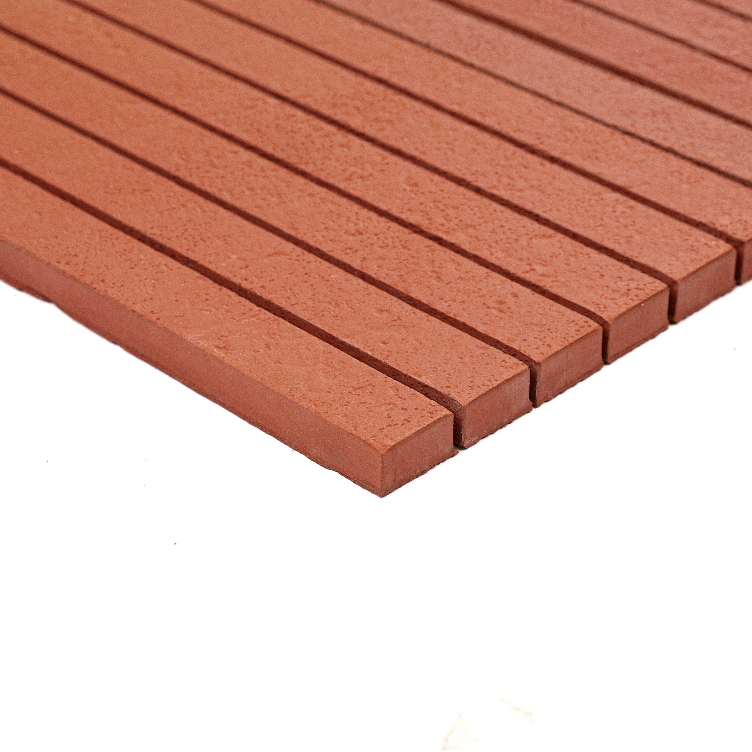 Close-up of textured terracotta mosaic tiles arranged in parallel rows on a white background