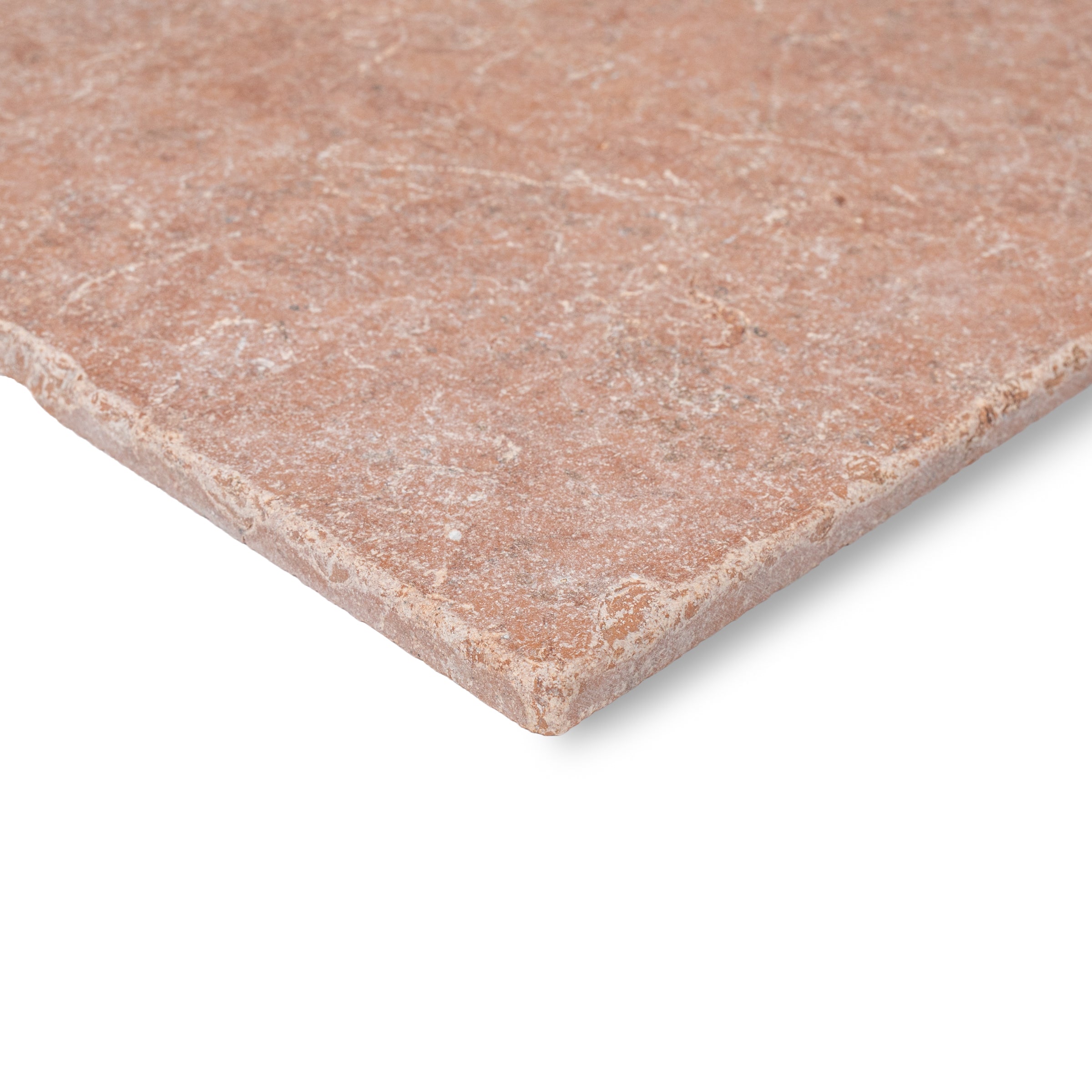 Close-up of a warm reddish ceramic tile with a tumbled surface and natural subtle veining on white background