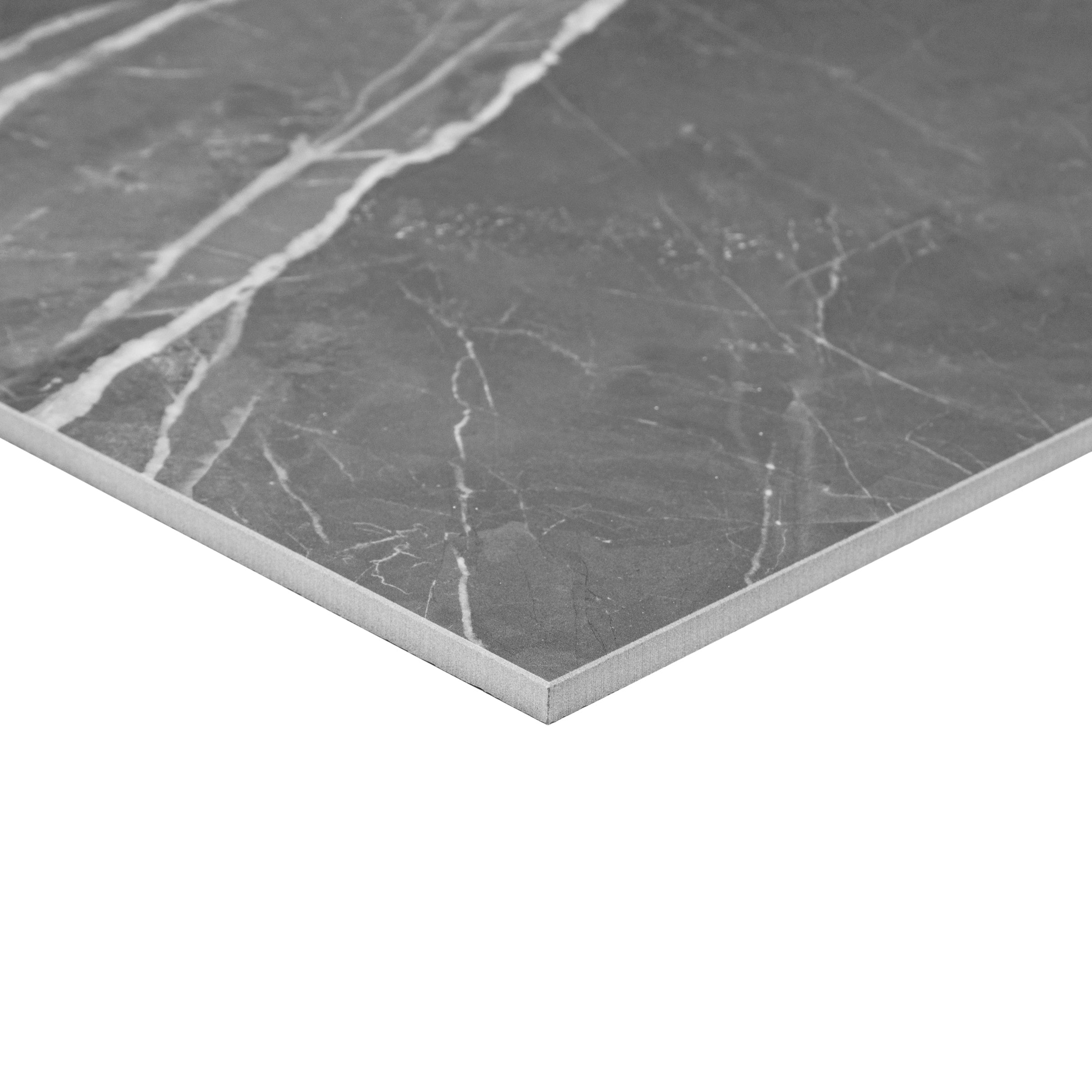 Close-up of a large-format matte porcelain tile in royal gray with subtle white veining and smooth edges