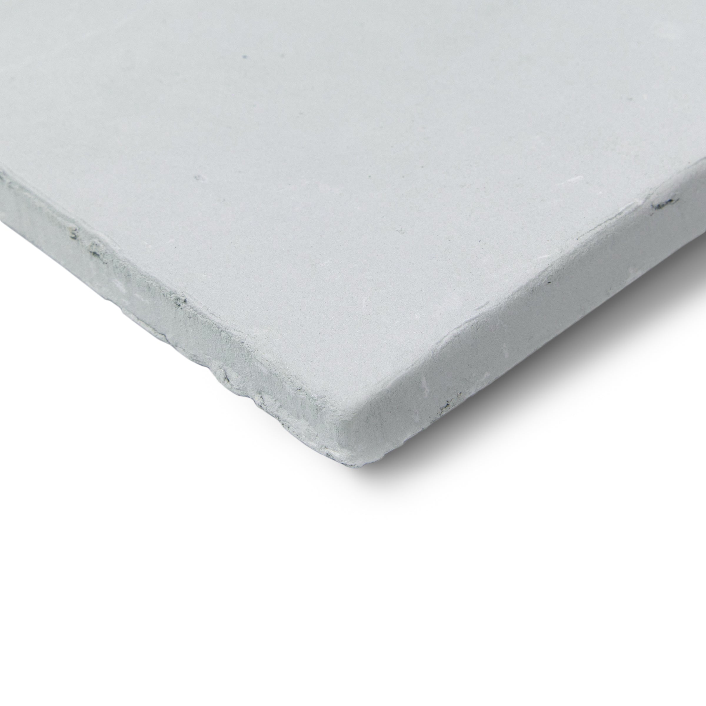 Close-up of a single white ceramic tile with a slightly rough, natural edge and matte finish against a white background