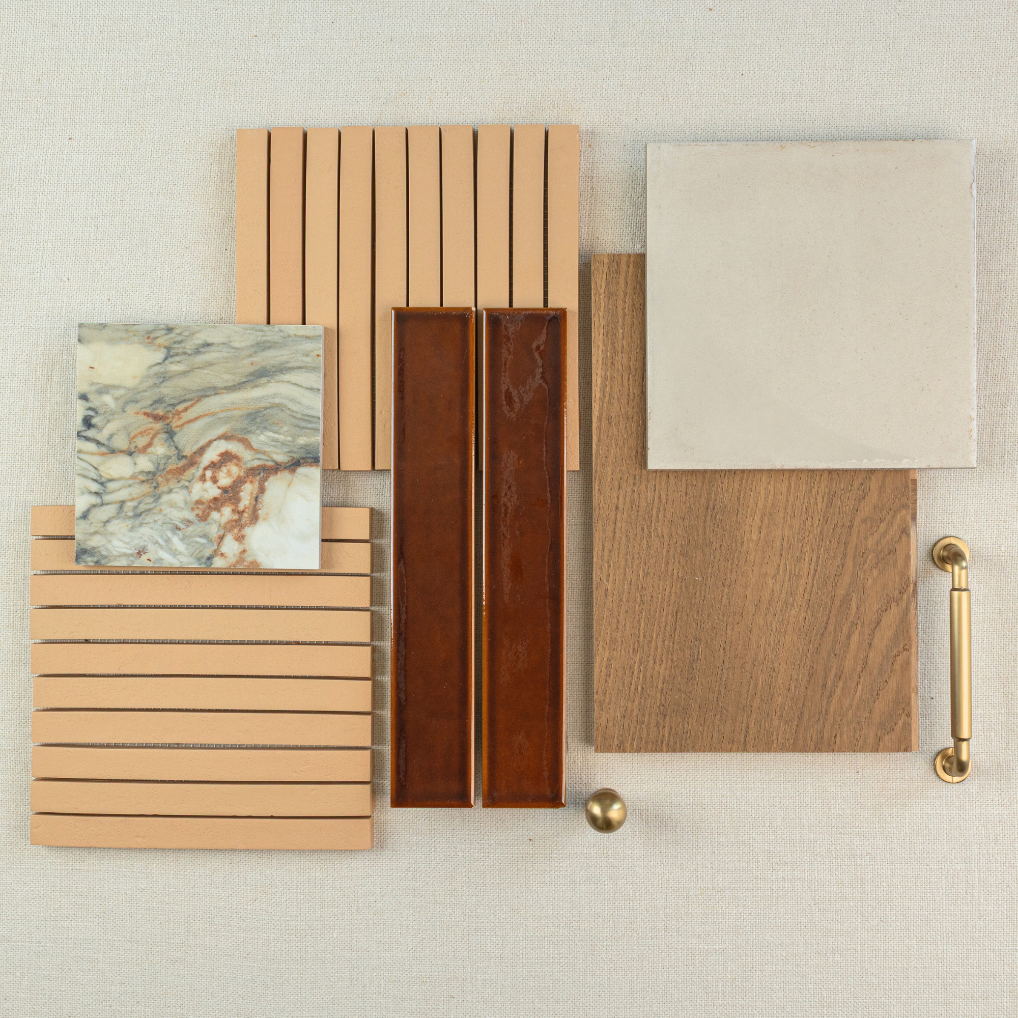Flat lay of ceramic tile samples including marble, terracotta strips, brown rectangular tiles, beige square tile, and wood plank with brass hardware accents