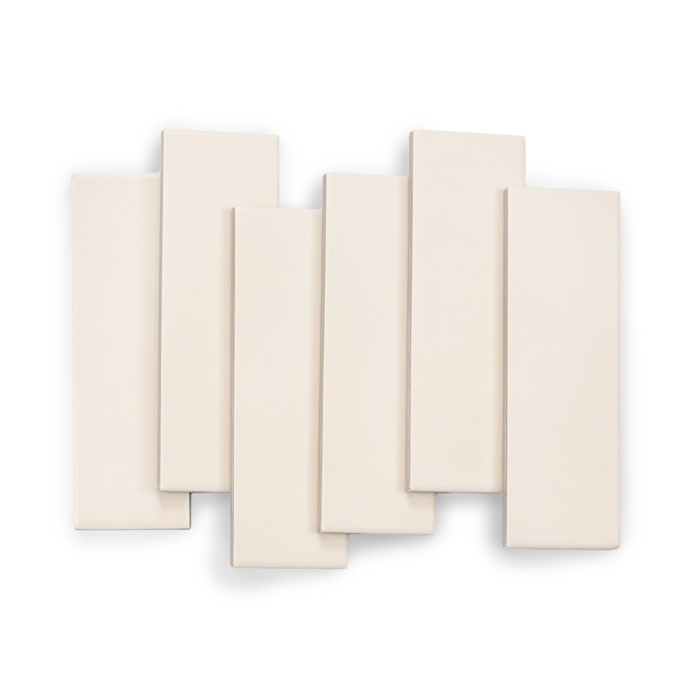 Assorted matte porcelain tiles in soft sandy beige with clean edges arranged in an overlapping layout
